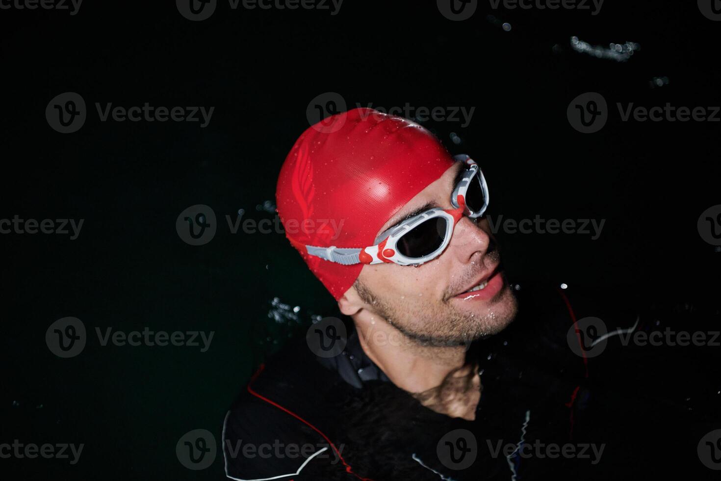 A triathlete finds serene rejuvenation in a lake, basking in the tranquility of the water after an intense training session photo