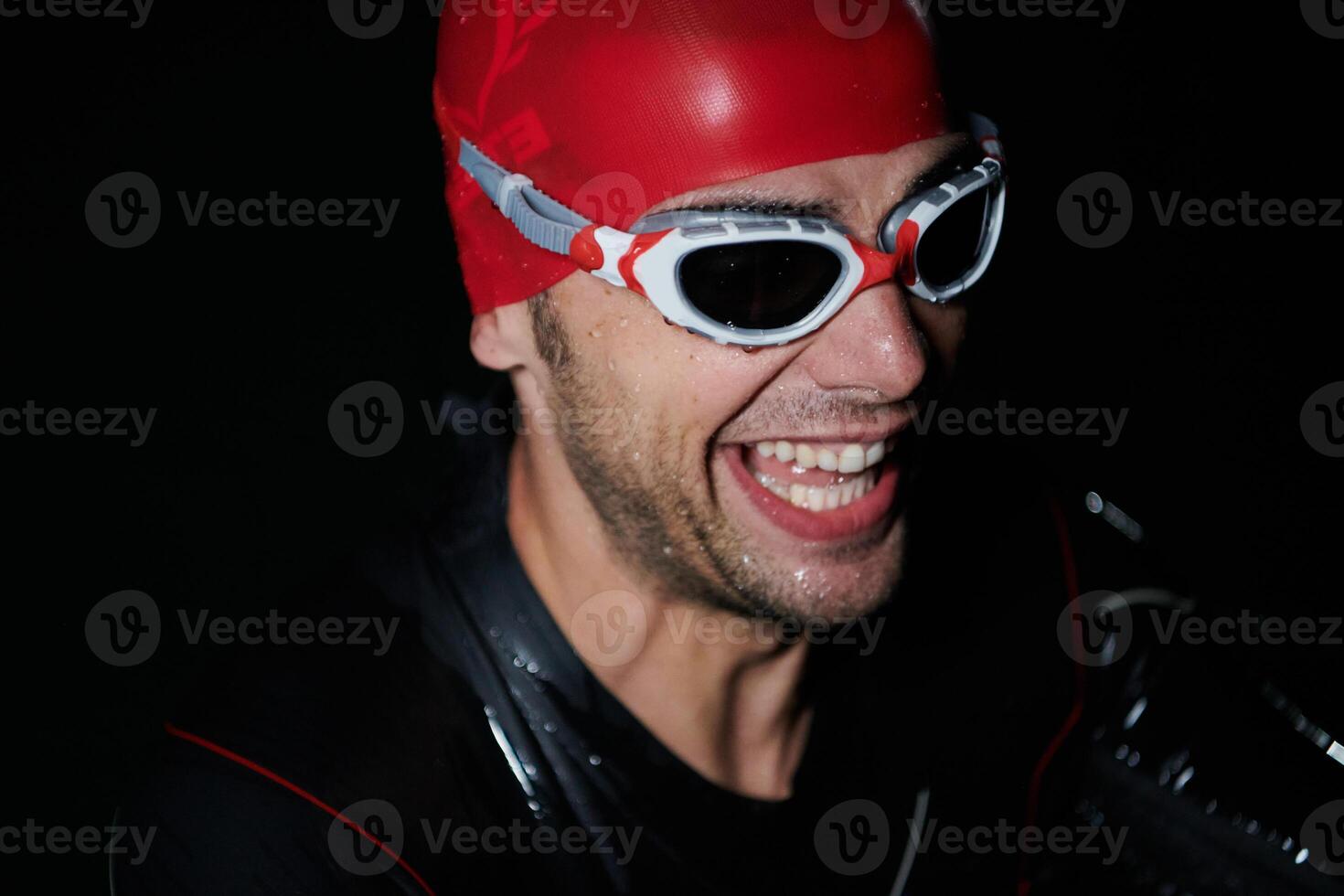 A triathlete finds serene rejuvenation in a lake, basking in the tranquility of the water after an intense training session photo