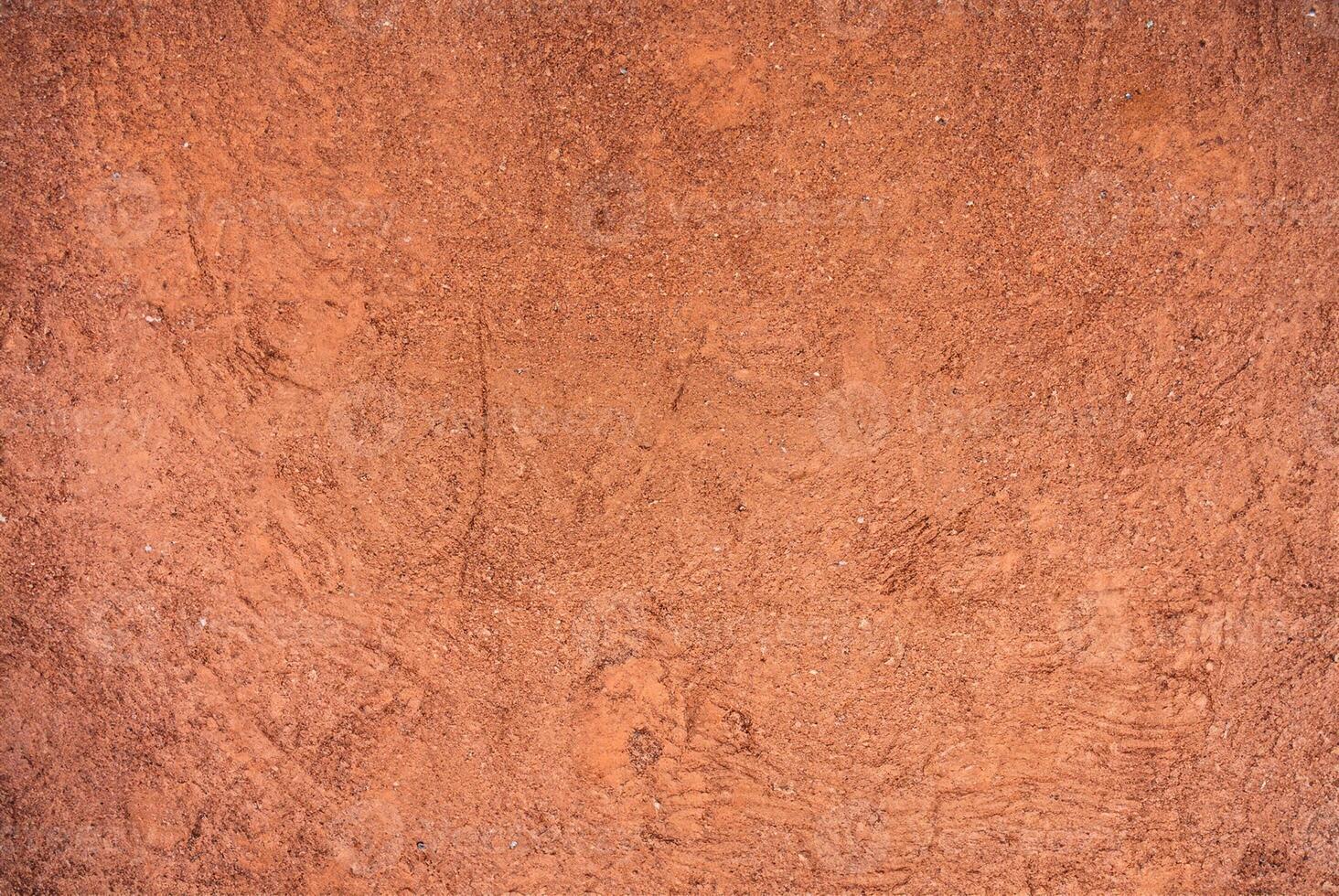 Red Sandy Surface Imprinted with Shoe Tracks, Texture Background photo