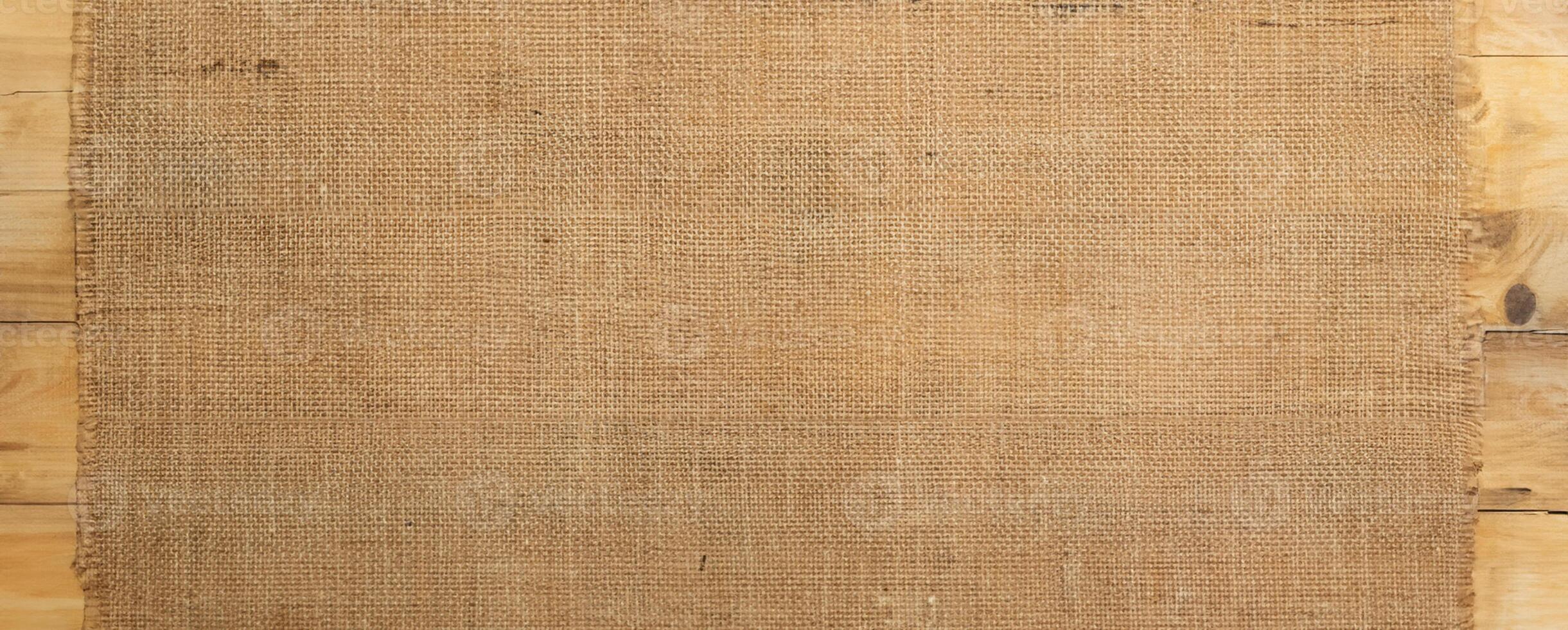 Burlap Fabric Texture on Wooden Surface, Rustic Background Concept photo