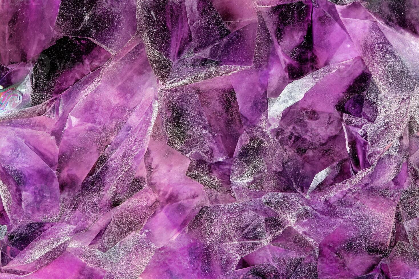 Close-up View of Raw Amethyst Quartz Crystals, Detailed Macro Shot of Purple Crystal Stone Surface photo