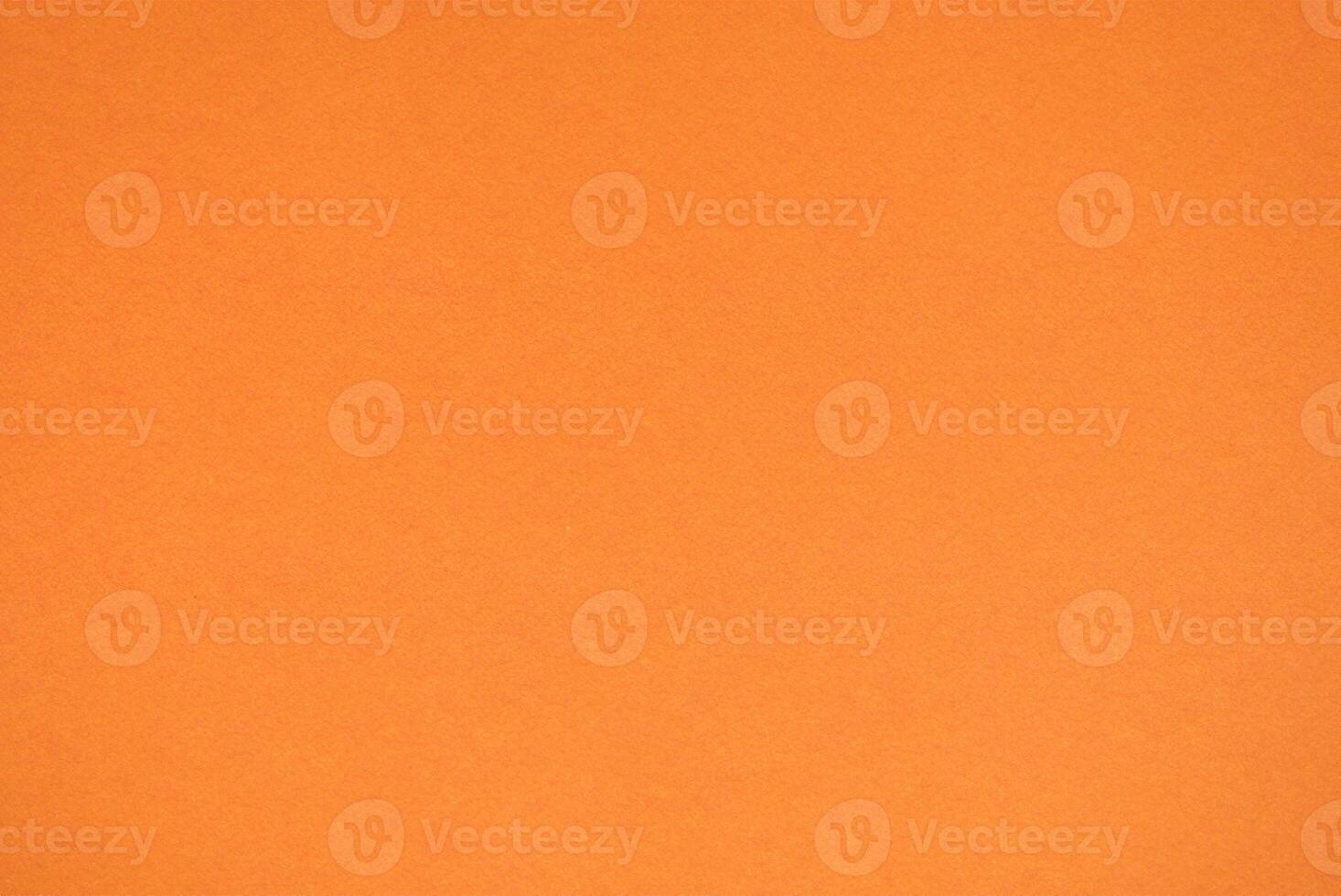 Close-Up Shot of Vibrant Orange Paper Texture photo