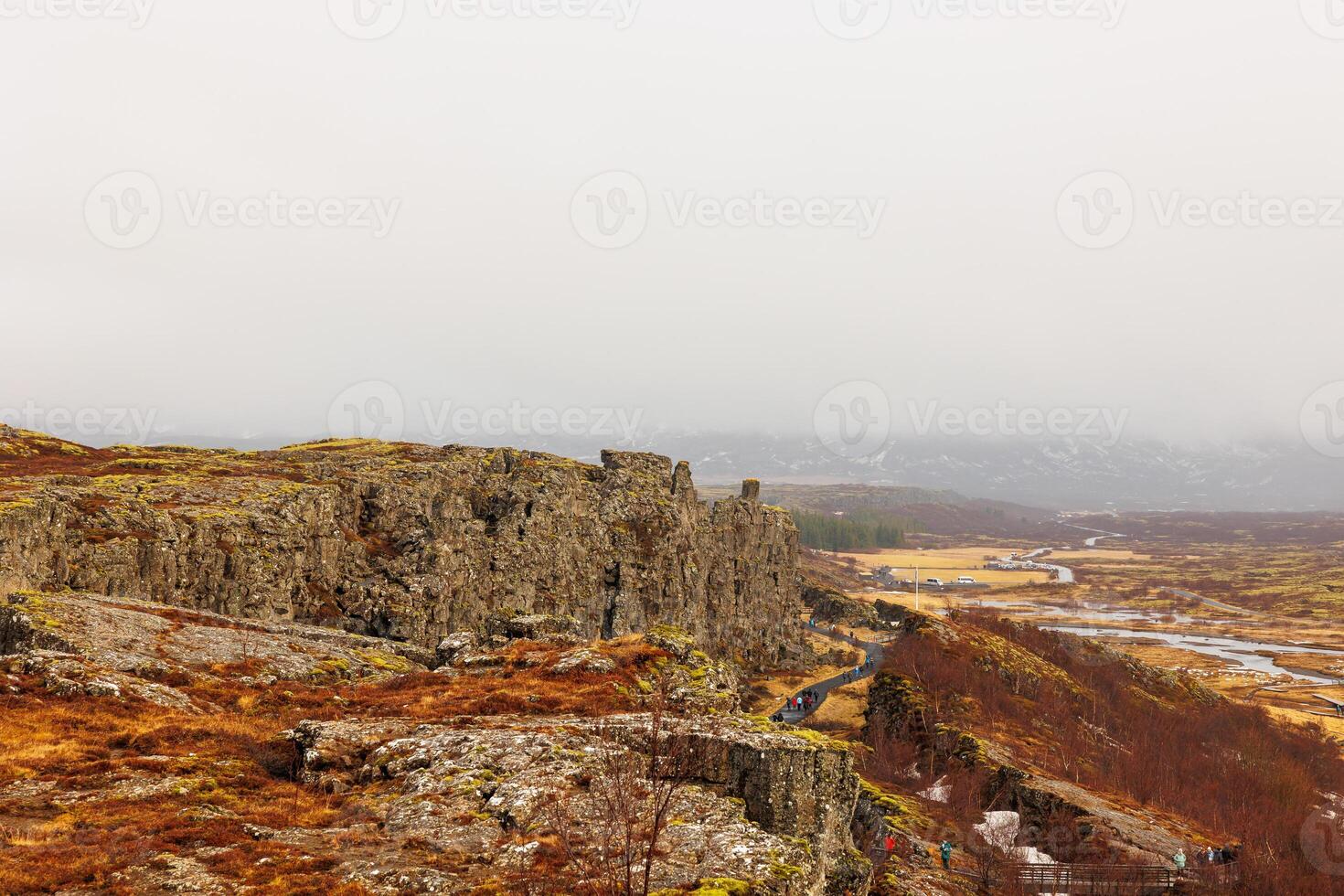 Steep highlands and river valley with rocks in Thingvellir national park, home to outstanding natural beauty. Breathtaking icelandic rocky hills and huge mountain walls, arctic scenery. photo