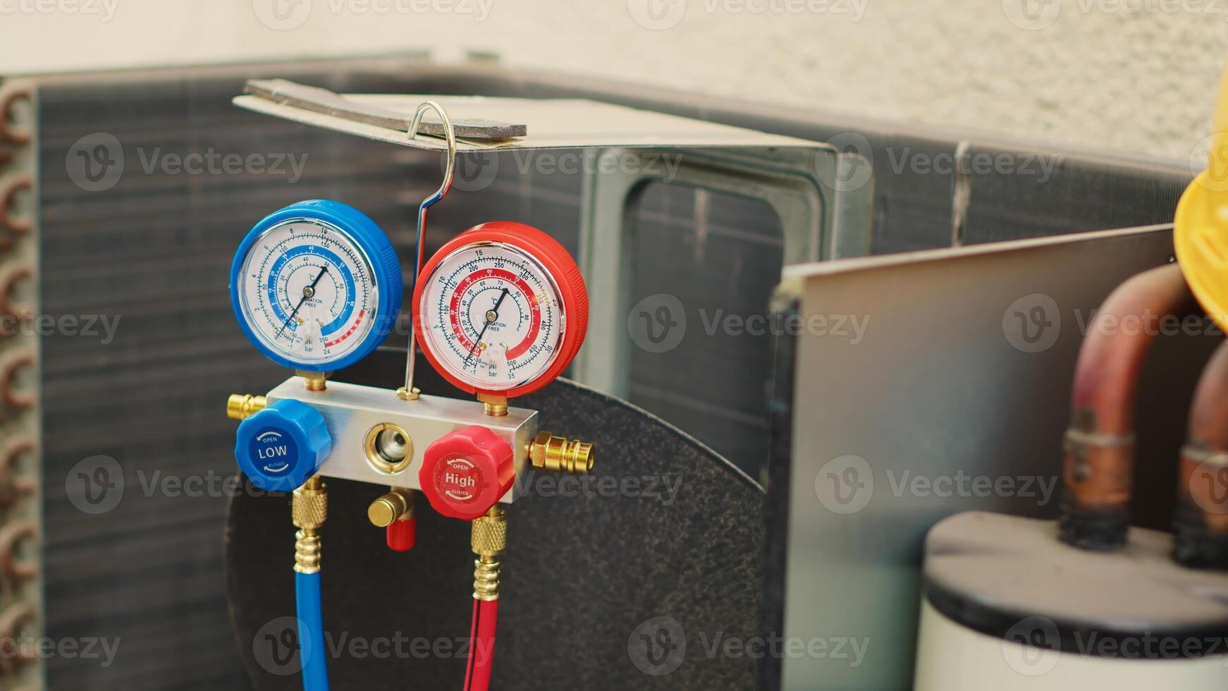 Dolly in close up shot of faulty pressure measurement device used for checking air conditioner refrigerant tank in need of fixing. Set of manifold indicators showing high or low freon levels photo