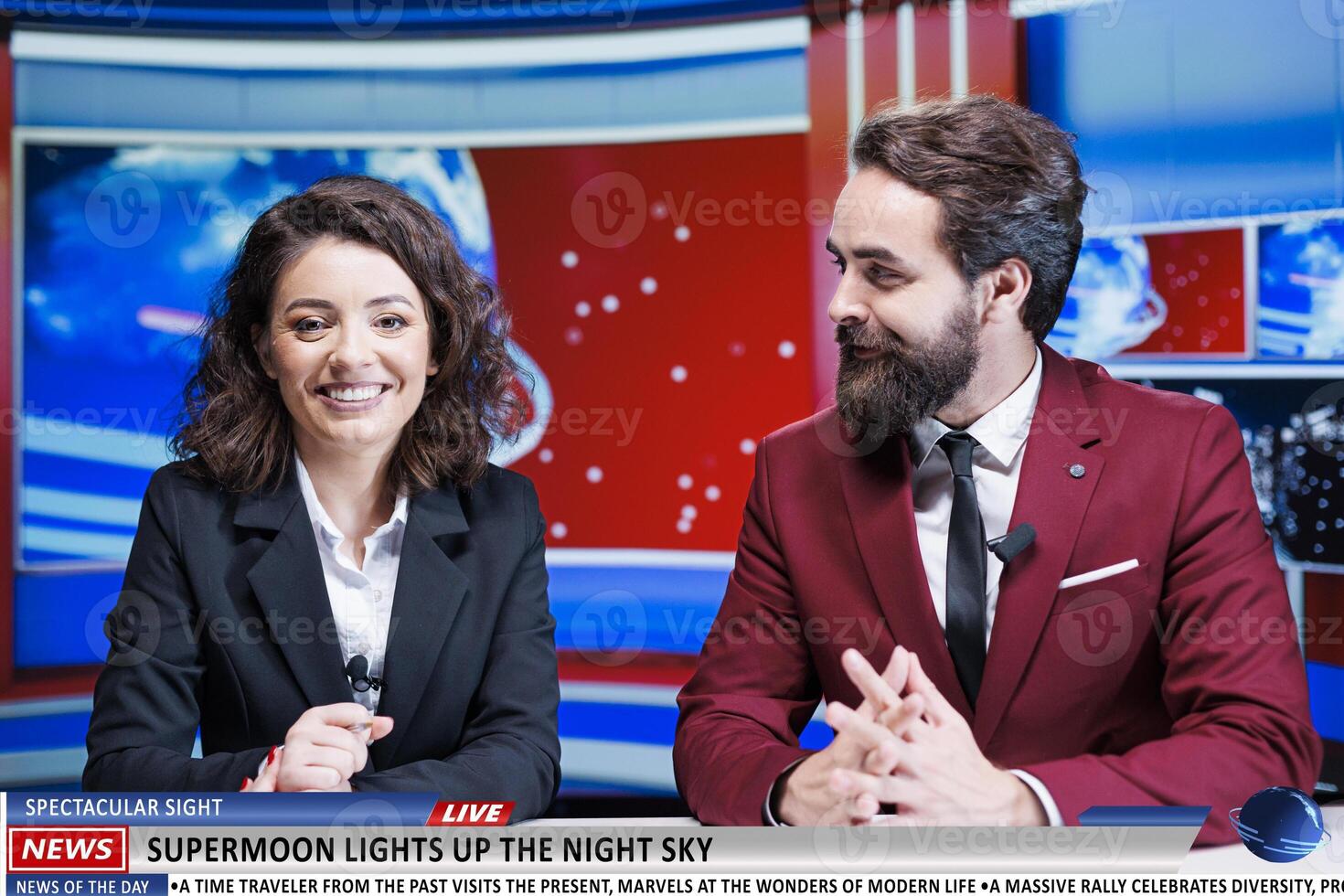 TV reporters talk about supermoon wonder in newsroom, news anchor team on morning show revealing information about magical astronomy sight. Man and woman journalists on live segment. photo