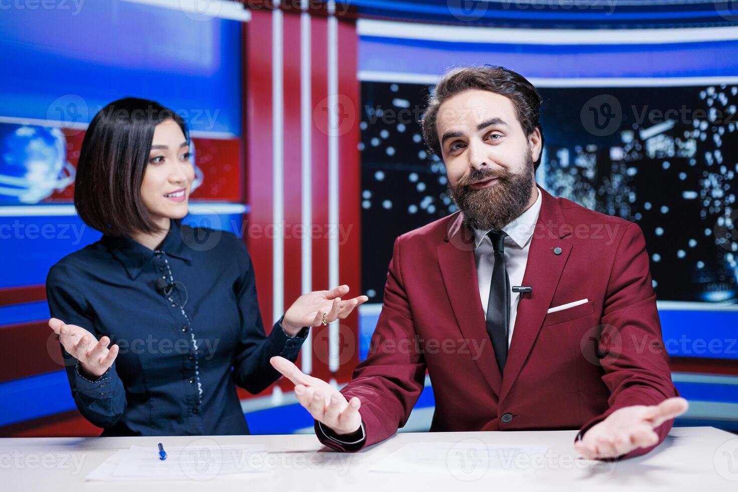 Journalists team present latest headlines in newsroom, using media papers to report daily exclusive information about events. Diverse newscasters working in television industry, creating reportage. photo