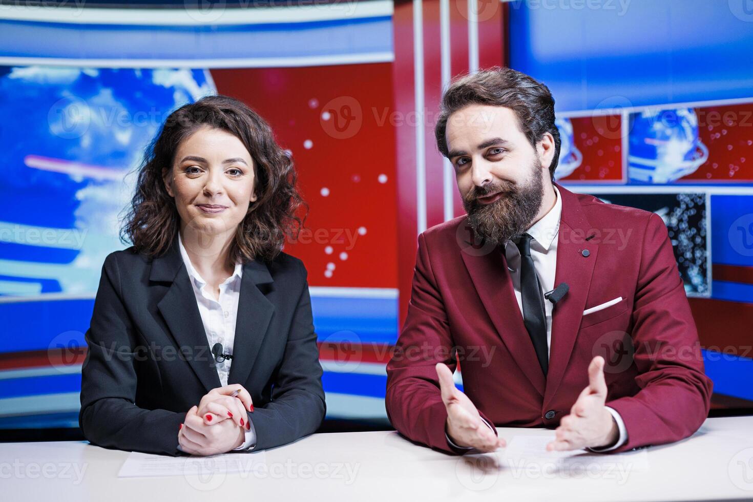 Media reporters going live on tv to present latest news and international events, transmitting broadcast on global television program. Team of presenters reading daily headlines in newsroom. photo