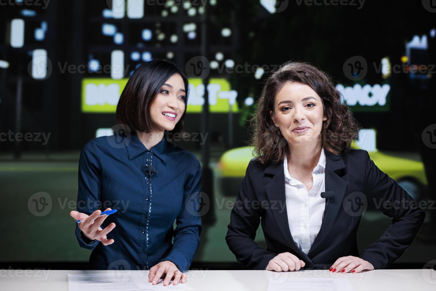 Night show hosts talk about events, reporting latest topics with exclusive information. Diverse journalists team presenting celebrity drama or daily news to create television content. photo