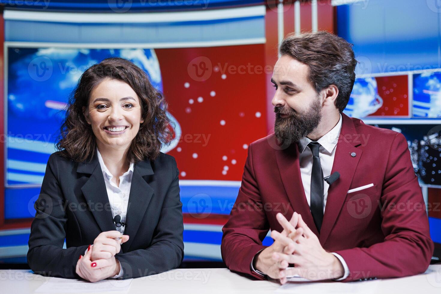 Show hosts going live on broadcast to read breaking news stories and international events, delivering television content from media newsroom. Team of journalists presenting headlines. photo
