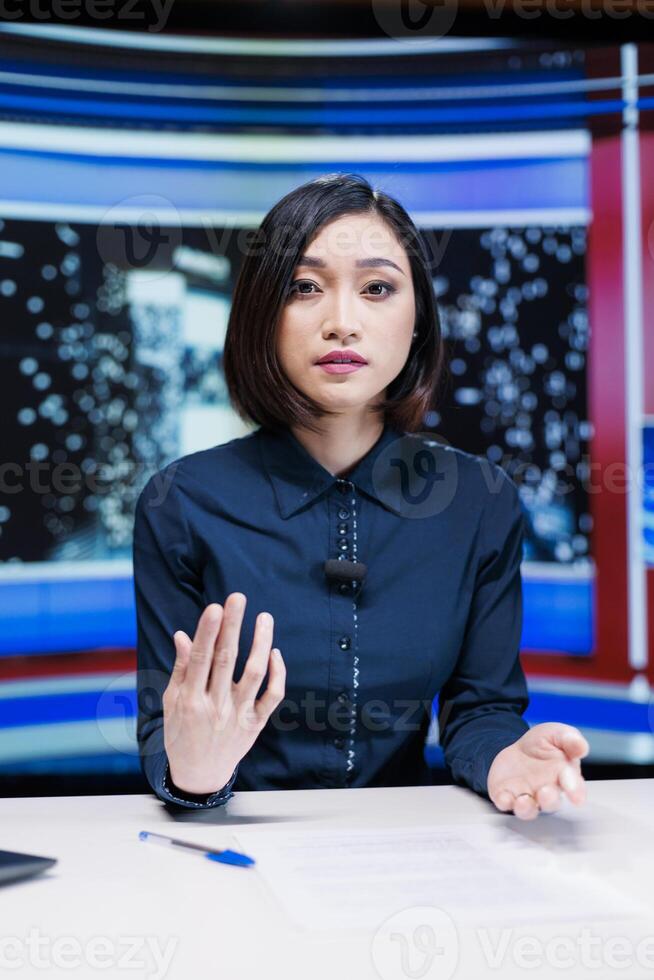 Reporter on night talk show presenting events during entertainment and media segment in newsroom. Woman journalist discussing about breaking news reportage with exclusive headlines. photo