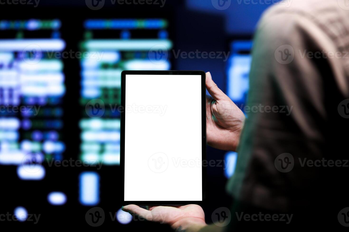 Specialist conducting yearly auditing of high tech facility servers using mock up tablet to optimize its lifespan, prevent system faults and ensure uninterrupted computing power photo