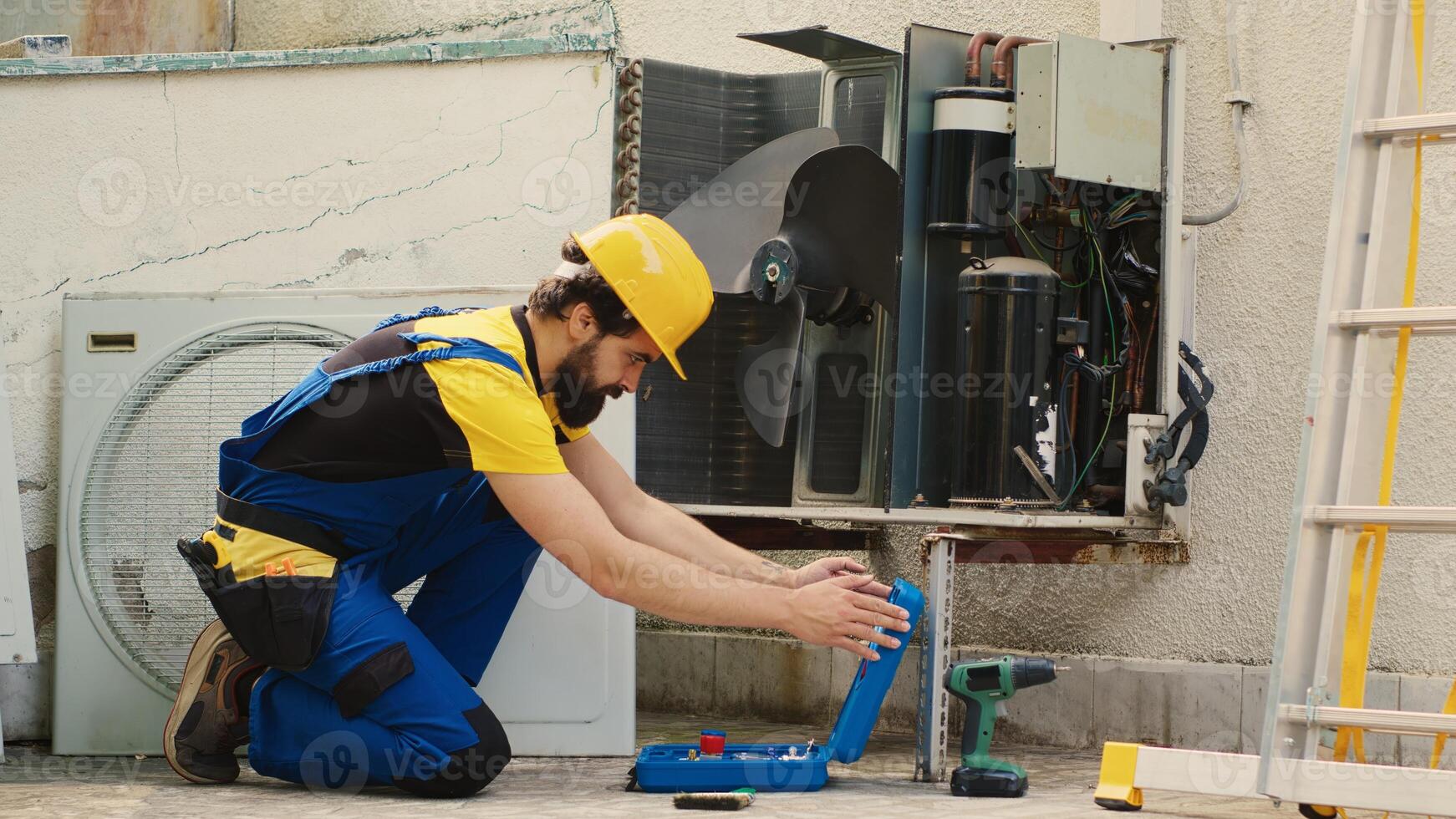 Skilled engineer commissioned for routine hvac system maintenance, assembling manometer before starting work. Repairman looking to find refrigerant leaks leading to reduced cooling efficiency photo