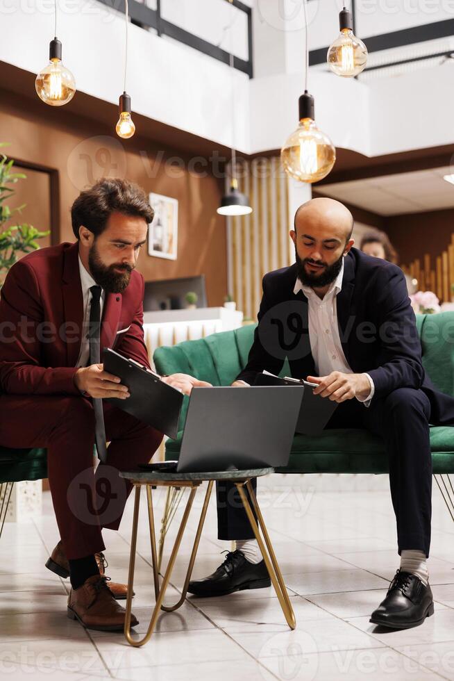 Coworkers collaborating at meeting, sharing diverse expertise to drive project forward for growth. Business partners engaging in discussions, strategizing ideas for the future, conference table. photo