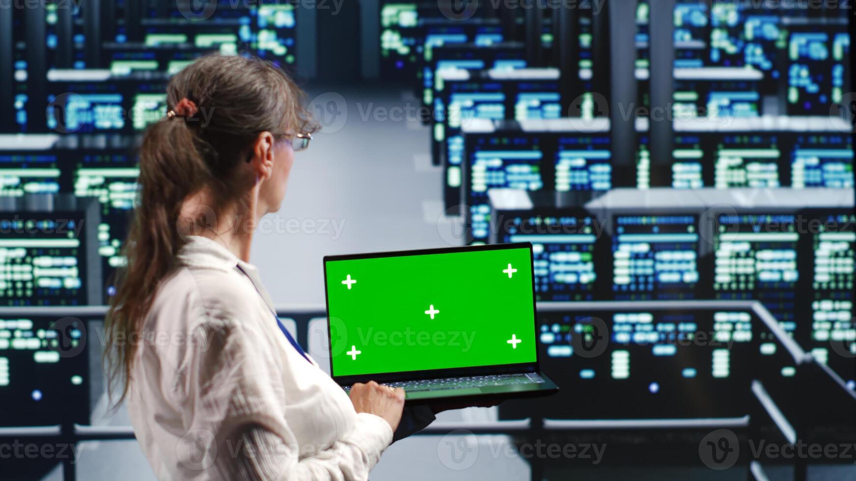 Older worker in server farm equipped to handle modern computing requirements, doing regular upgrades to infrastructure, increasing processing power and storage capacity to prevent problems photo