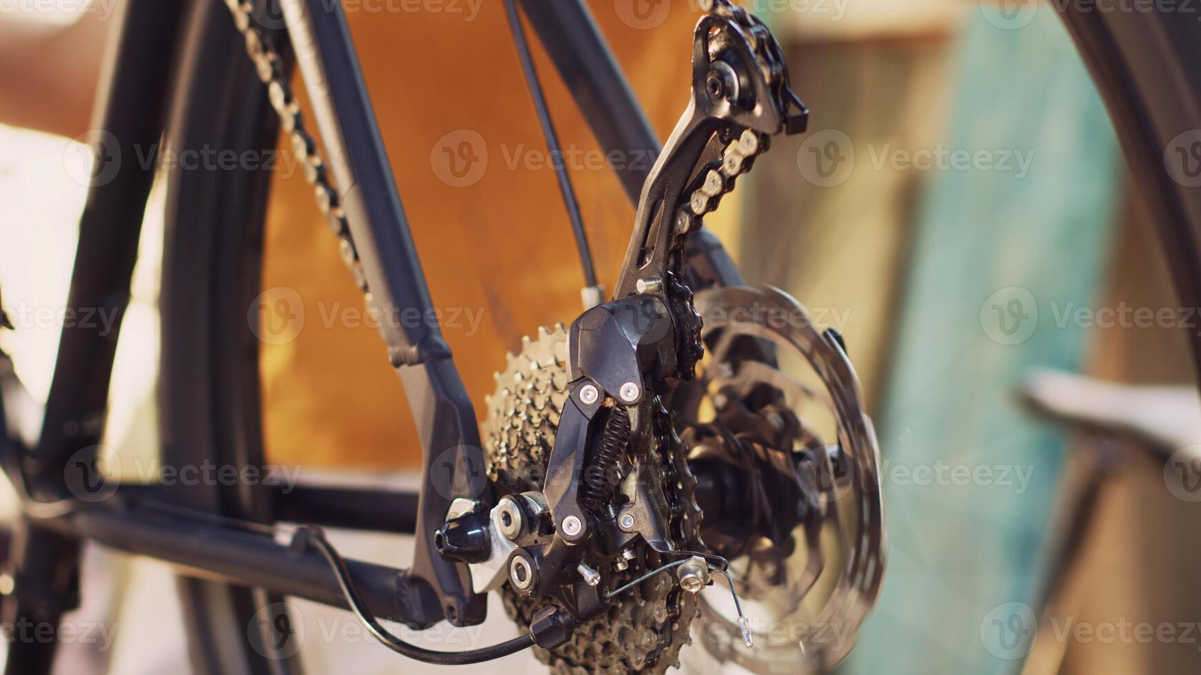 Close-up shot of man servicing and adjusting of bike rear derailleur and cogset outside for outdoor cycling. Detailed view of bicycle wheel revolving for close examination for damages. photo