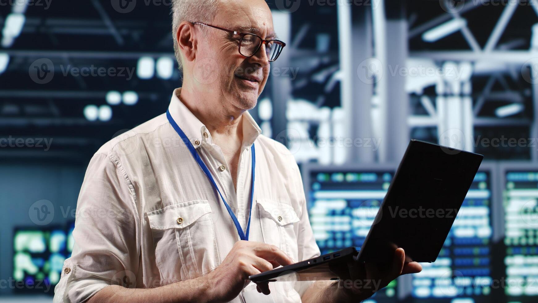 Proactive professional navigating network of server hardware in industrial hub. IT consultant with laptop doing optimizations and maintenance in data center, preventing system errors photo
