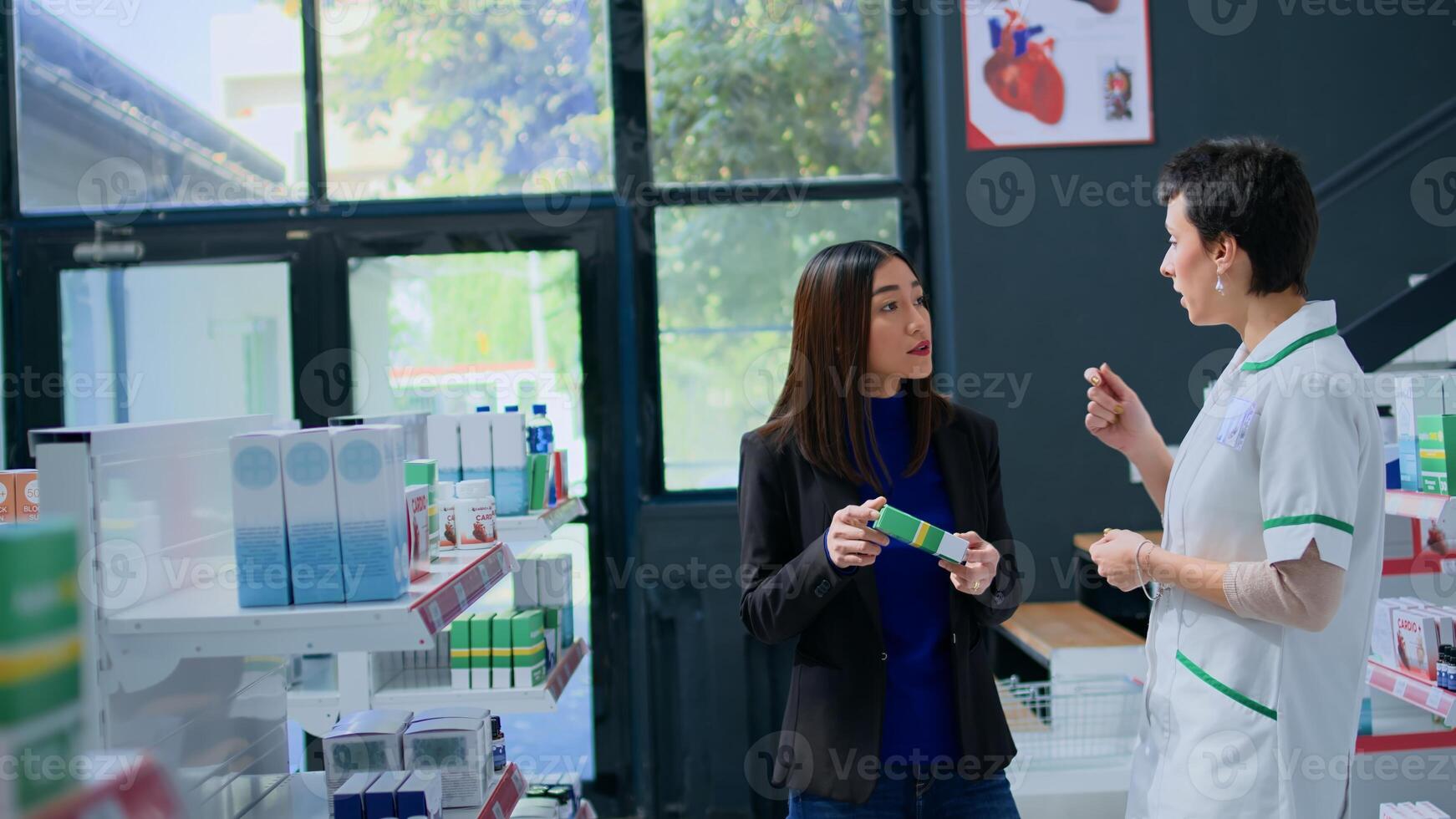 Asian client in modern drugstore asking trained pharmacist for medical expertise. Licensed druggist helping customer trying to pick best pharmaceutical product to reduce pain photo
