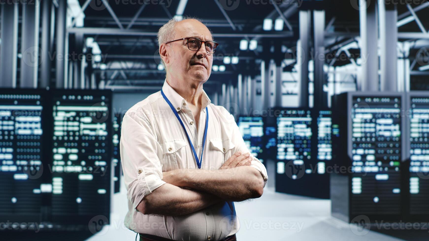 Portrait of elderly engineer looking around modern server room in data center, preparing to start comission on malfunctioning high tech facility hardware rigs in order to ensure errorless operations photo