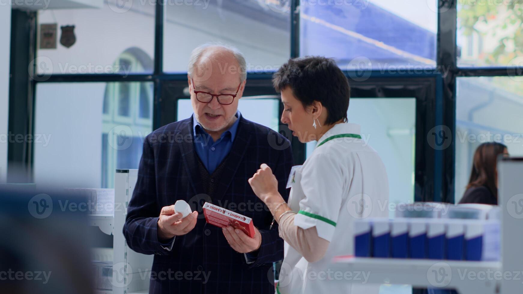 Proficient pharmacy heart specialist helping elderly man with medical suggestions. Senior client in dispensary wishing to purchase cardiologist prescribed medicaments, asking expert for guidance photo