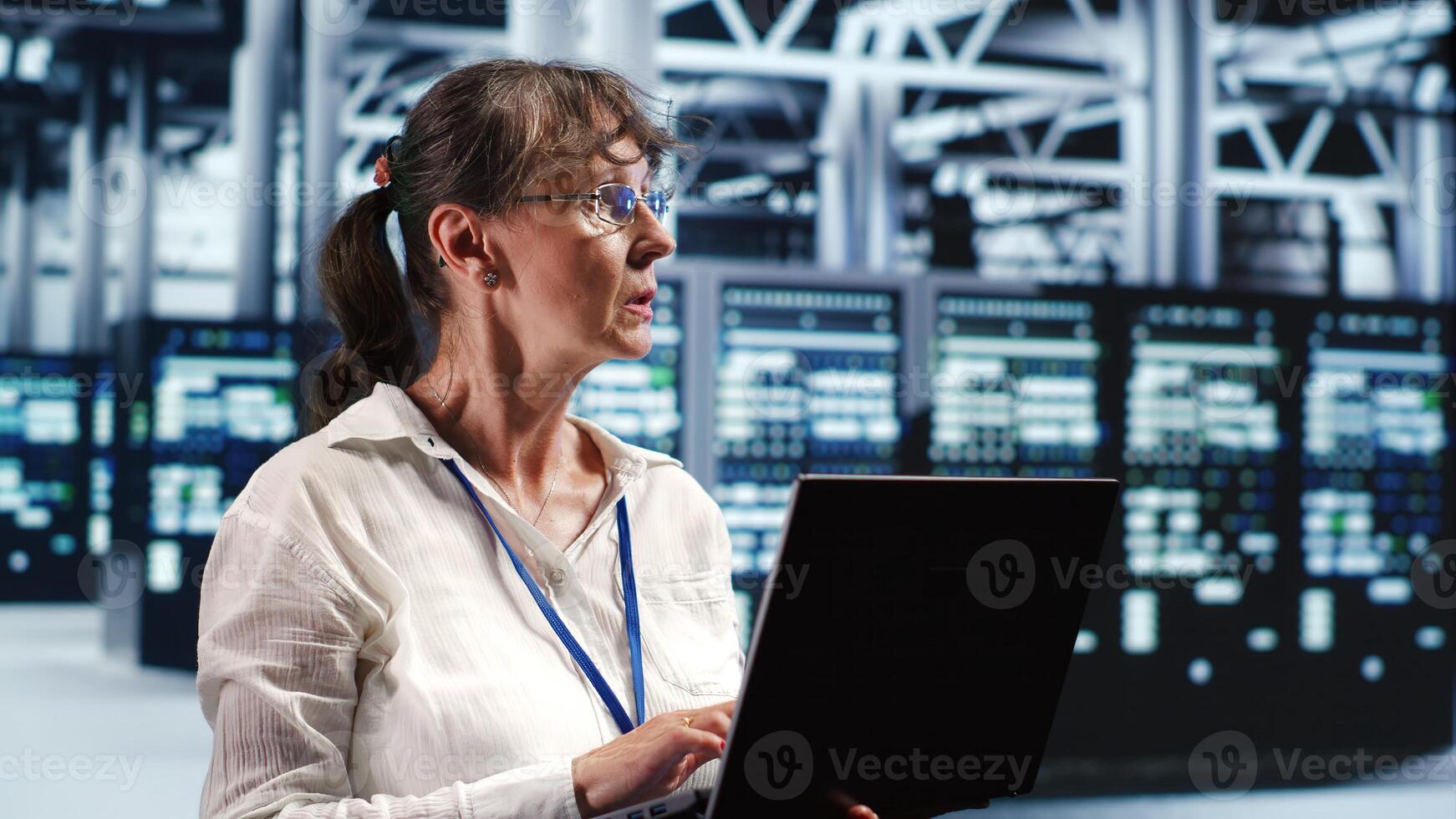 Adept computer scientist looking around cutting edge data center, preparing to start comission on defective high tech server mainframes in order to ensure secure operations photo