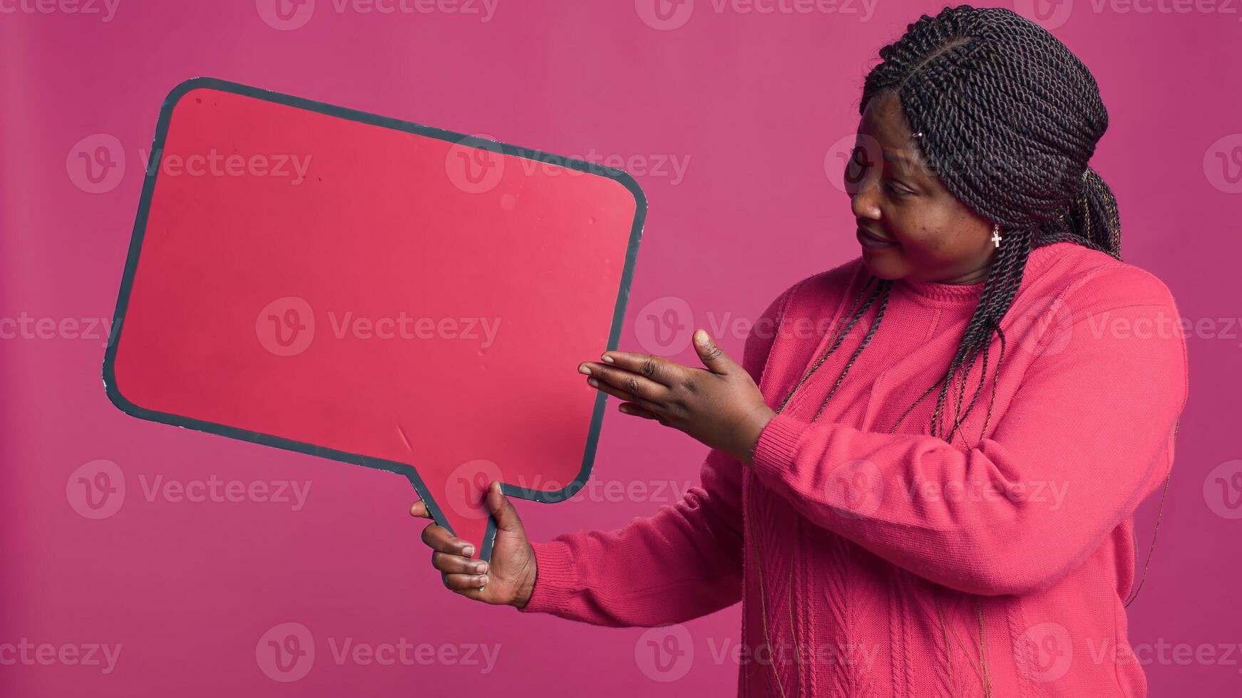 African american beauty grasping red speech bubble mockup in right-hand for text messages and notes. Black woman showing approval of information on word bubble copyspace template. photo