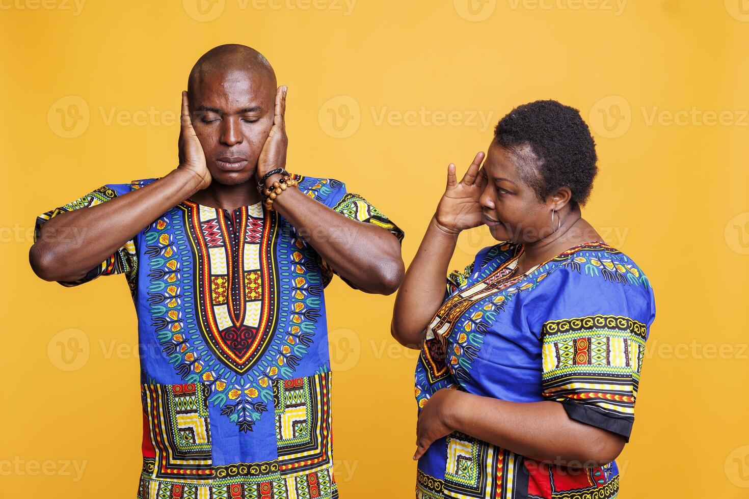 African american couple ignoring each other during quarrel and having misunderstanding concept. Black mature wife and husband wearing ethnic clothes having relationship crisis photo
