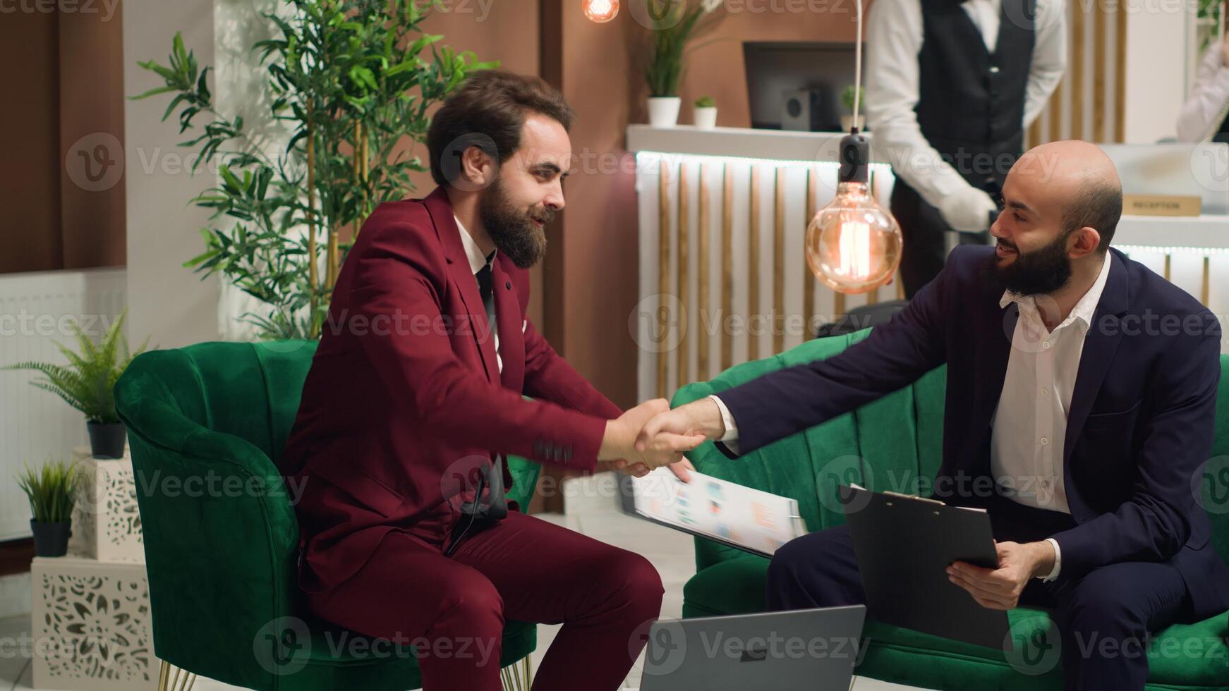 Professionals agree on collaboration with handshake, creating new project to develop company shares. Associates working together to help increase finances at conference abroad. photo