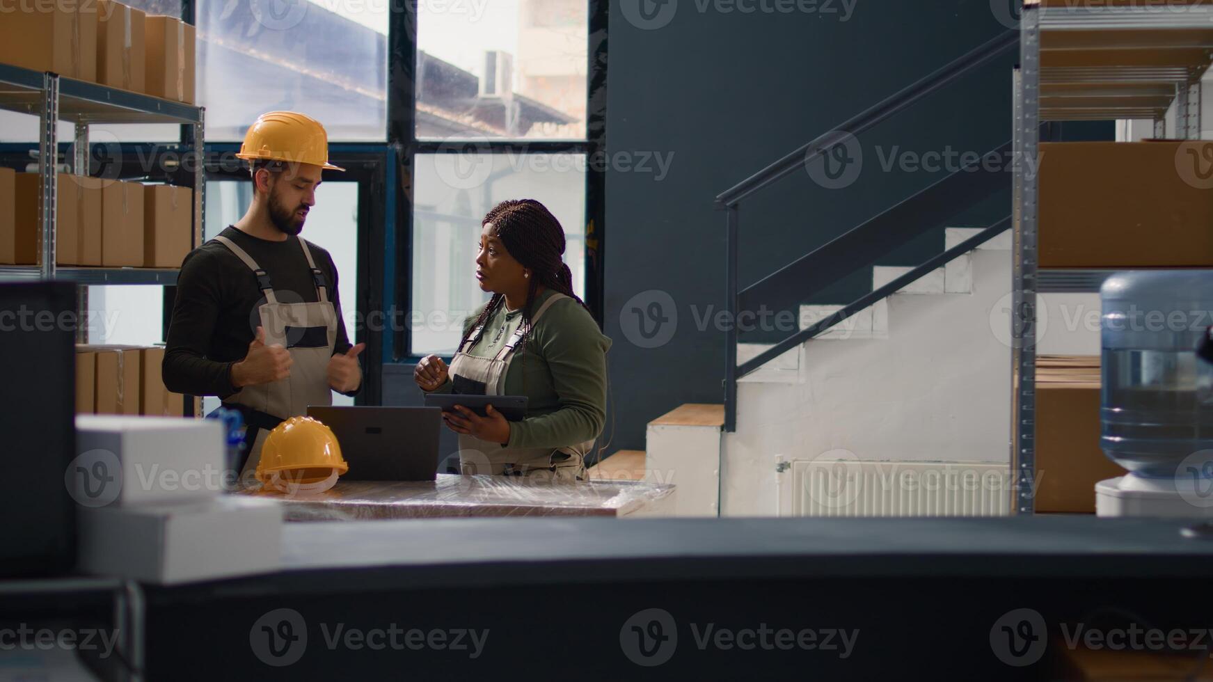 Dolly out shot of employees doing warehouse inventory analysis, keeping quality standards high. Experts in storage room checking labels on stockpiled merchandise, crosschecking delivery info photo