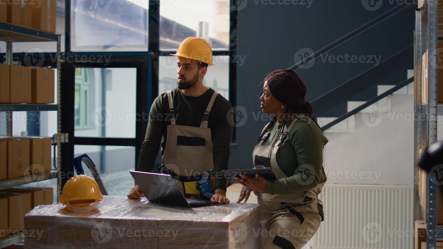 Dolly out shot of employees running warehouse inventory investigation operations, keeping quality standards high. Experts in storage room check labels on cardboard boxes, crosschecking delivery info photo