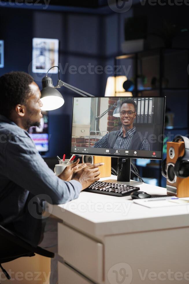 Tutor attending training course videocall with junior employee, teaching him to solve company tasks and operations. Mentor and trainee discussing about job while telecommuting on web. photo