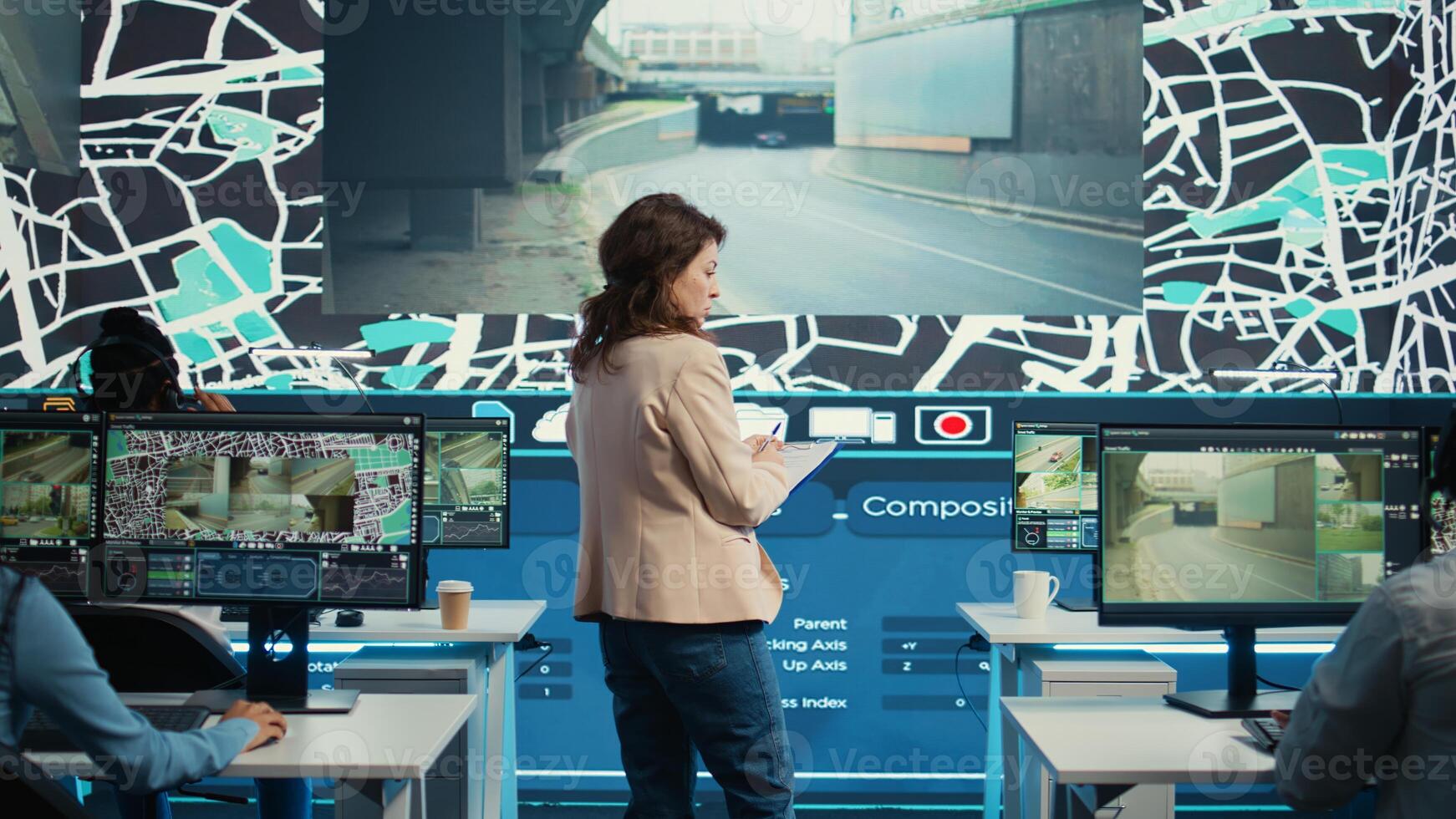 Manager supervising diverse employees operators in delivery call center office, people using global positioning system to guide shipment cars on city routes via satellite navigation map. Camera B. photo