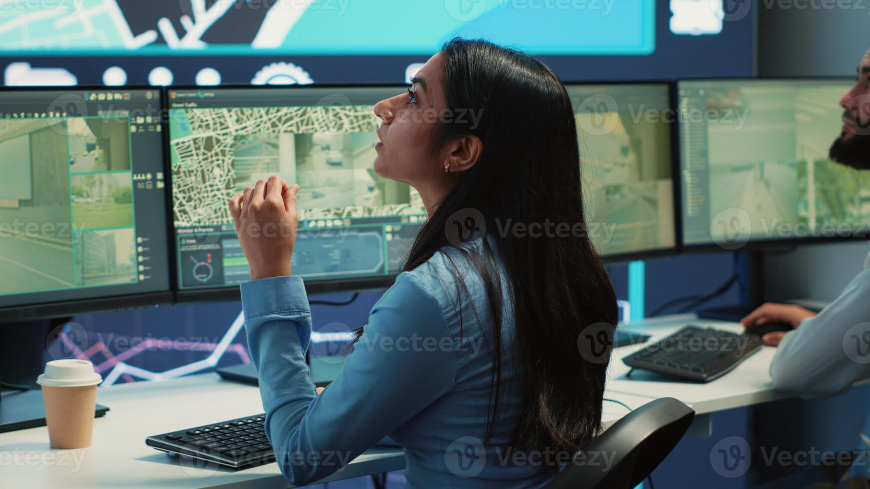 Indian operator transmitting gps coordinates for couriers to deliver orders, following awb information and satellite map to avoid traffic. Employee sending directions and cargo location. Camera A. photo
