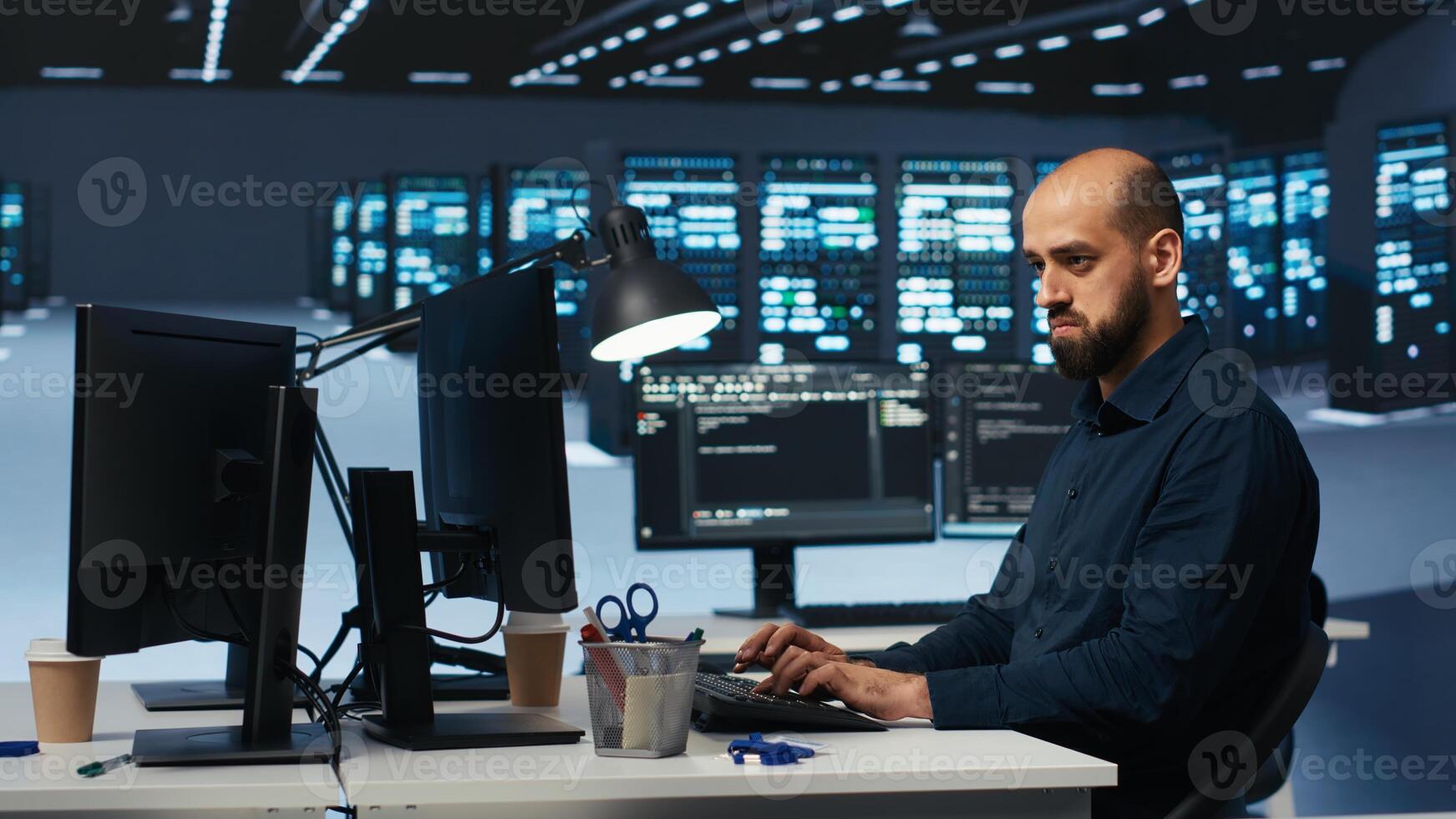Man programming in high tech facility with server rows providing computing resources for different workloads. Admin reviewing data center supercomputers tasked with solving complex operations photo