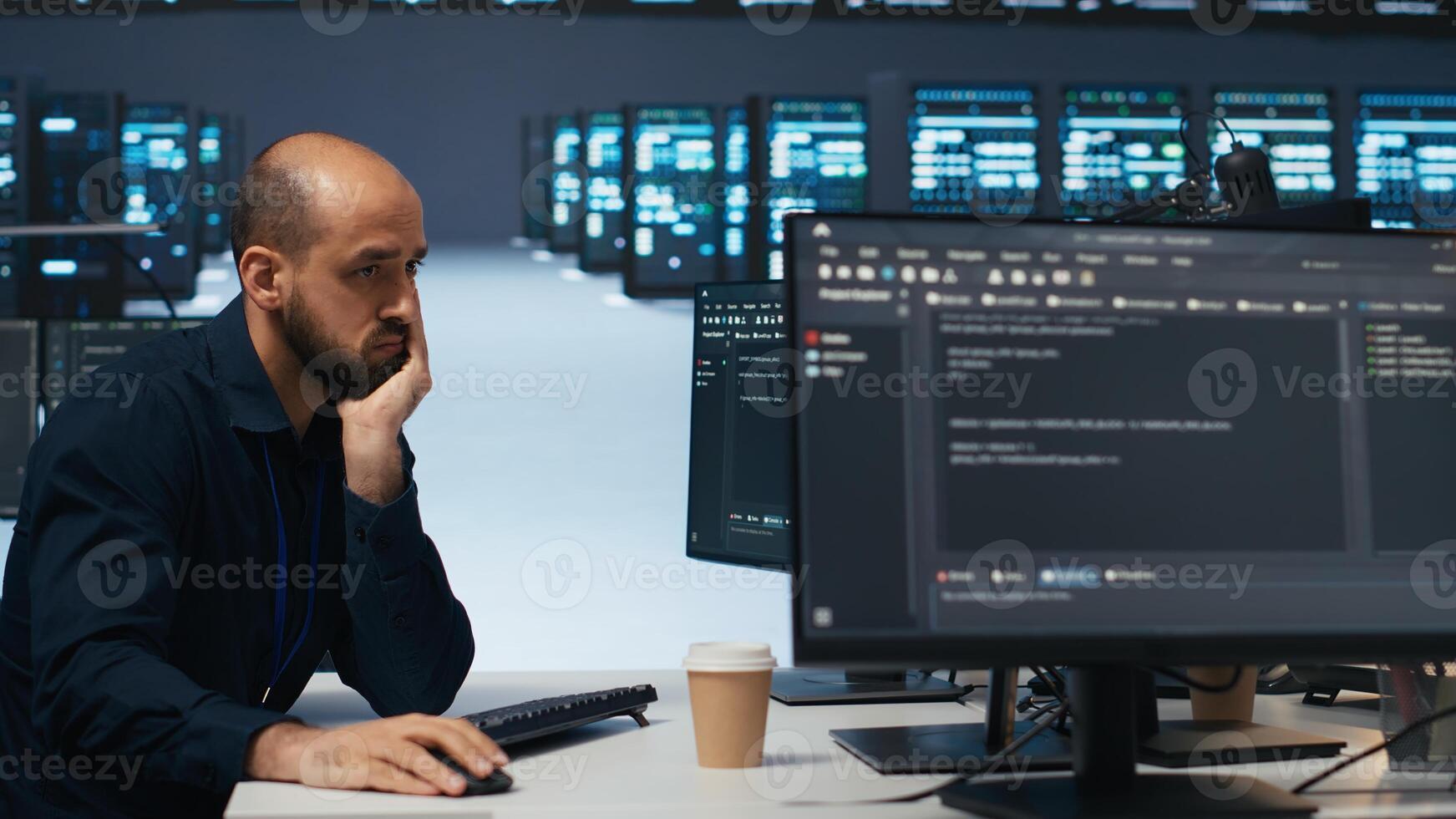 Technician using PC in high tech server hub facility to safeguard data from intruding hackers. Engineer protecting blade servers against unauthorized access, securing system from malicious traffic photo