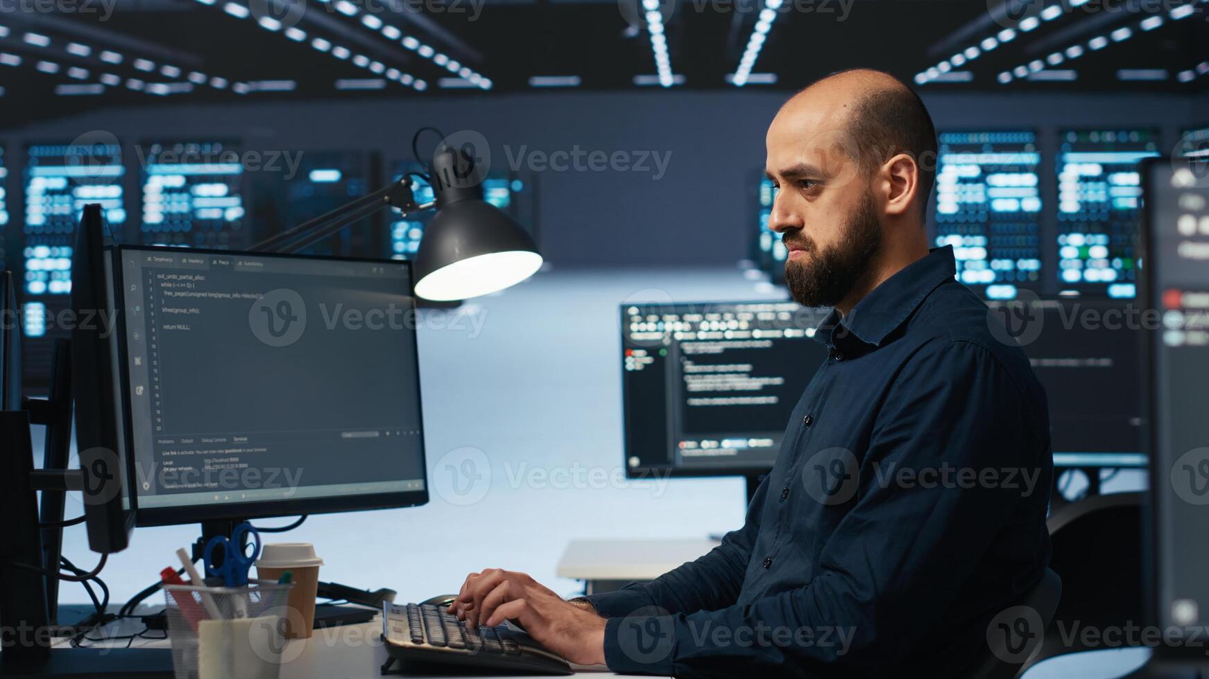 Software developer programming in high tech facility with server rows providing computing resources for different workloads. IT expert reviewing data center supercomputers photo