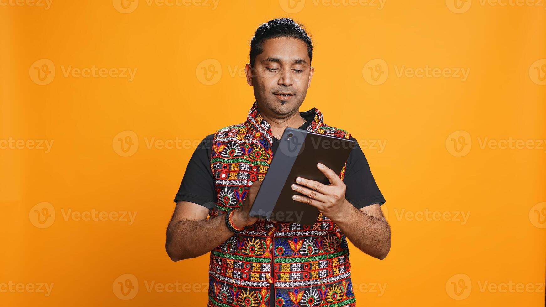 Man shakes head in disbelief after realizing lack of necessary funds while trying to shop online on tablet. Disappointed indian person gets credit card transaction rejected, studio backdrop, camera B photo