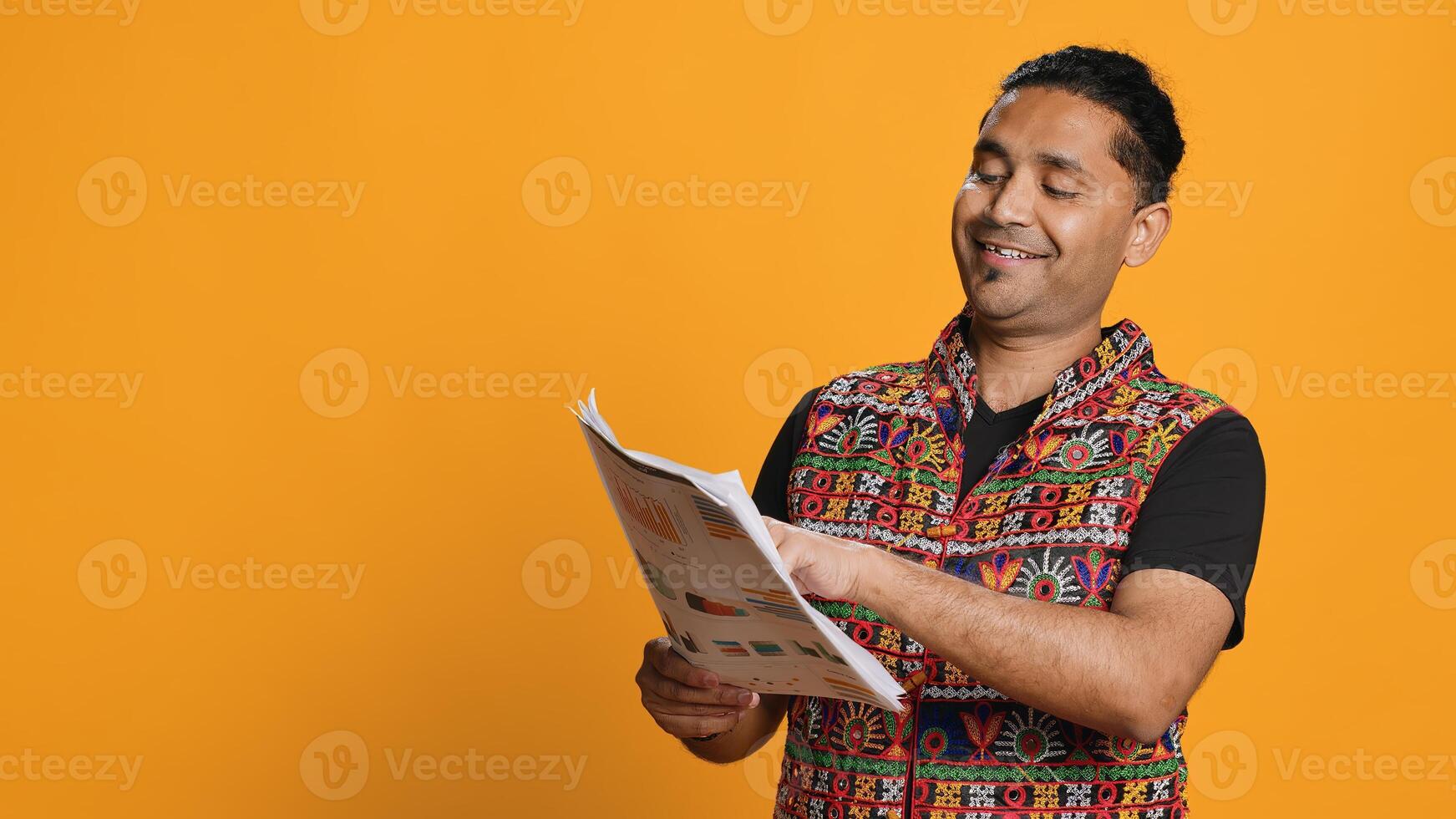 Accountant doing profit analysis for company, browsing files, isolated over studio background. Worker doing financial budgeting and forecasting, looking over paperwork graphs, camera A photo