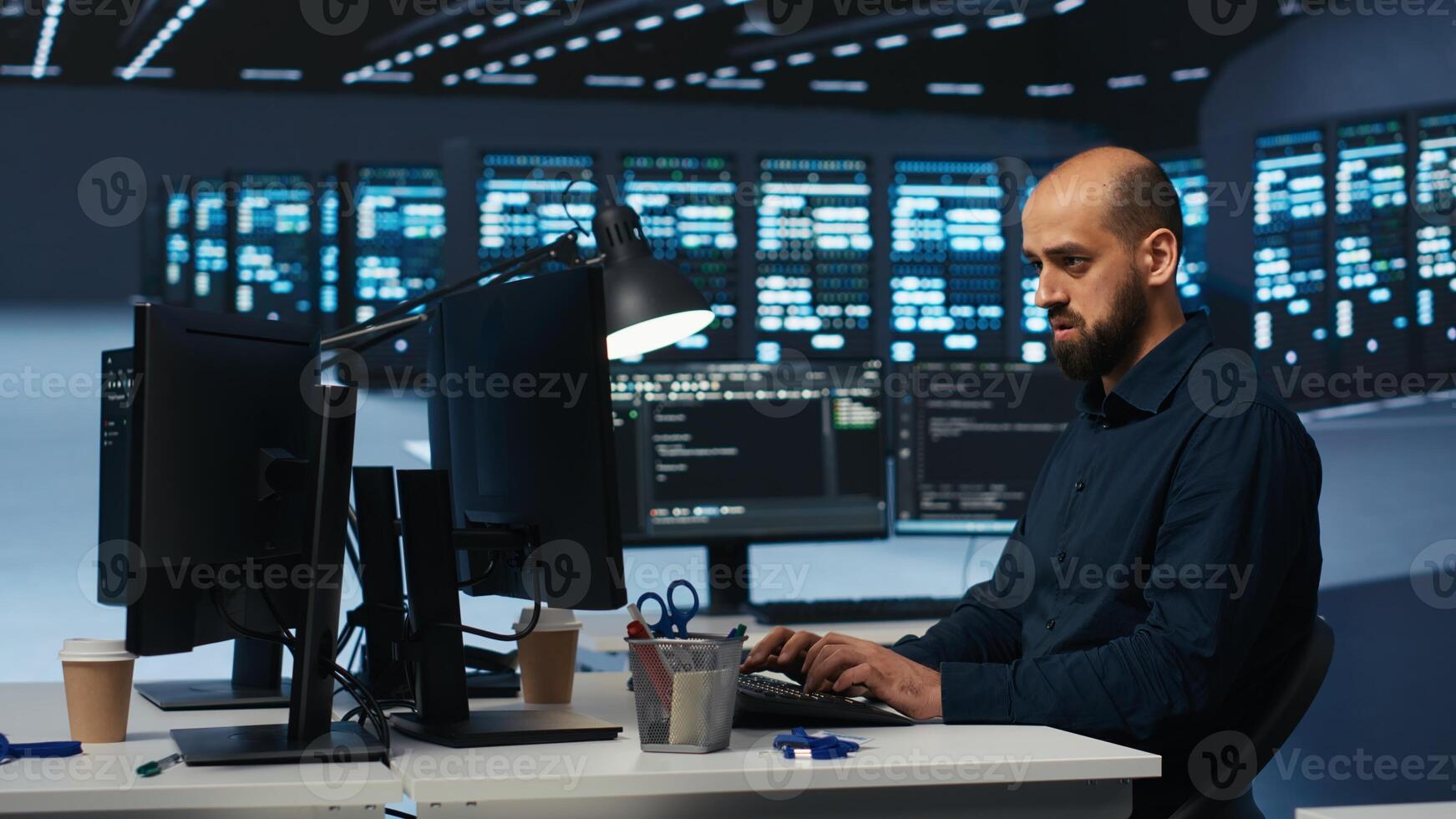 System administrator programming in server farm housing advanced equipment storing massive datasets. Programmer running code on PC to mend data center racks doing complex computational operations photo
