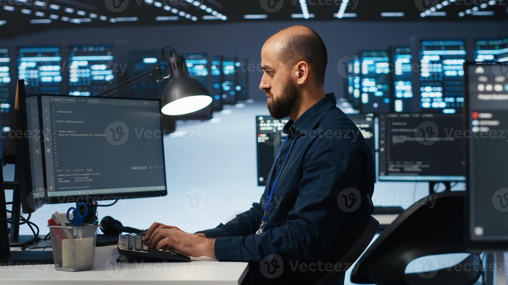 IT specialist in server farm ensuring valuable data remains shielded from potential threats, safeguarding against unauthorized access and vulnerabilities, securing system from virus attacks photo