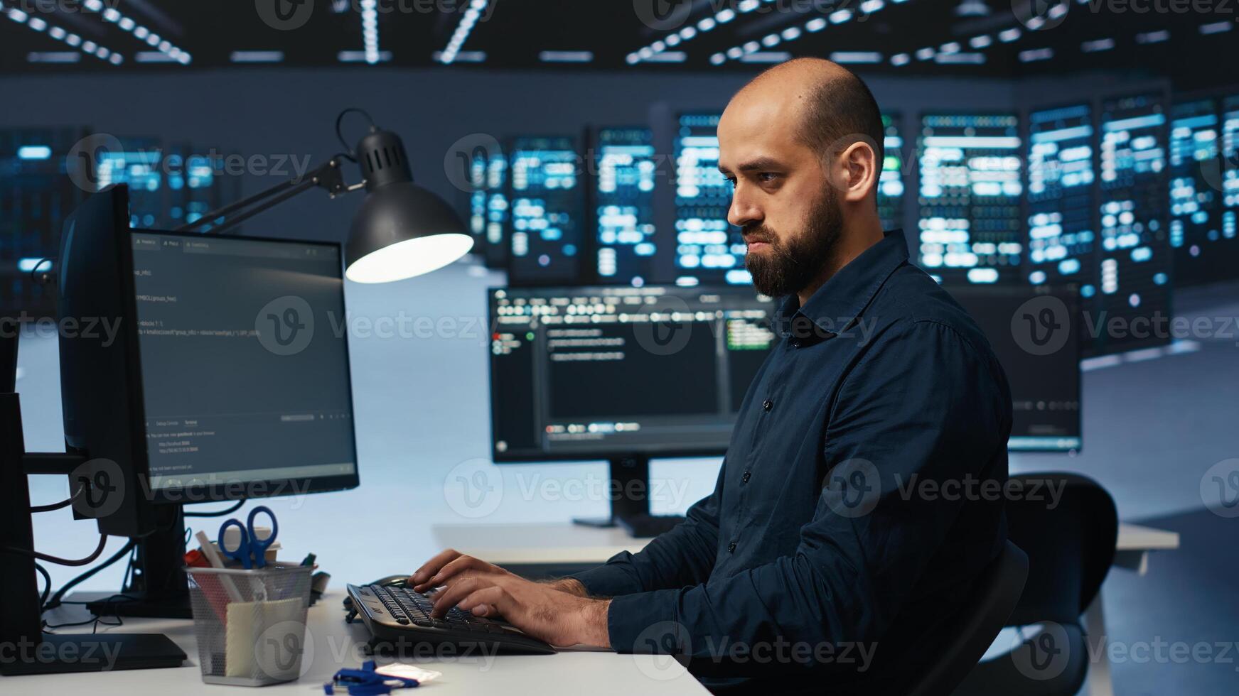 IT engineer overseeing server room, running code on computer, troubleshooting servers. Programmer at work upgrading hardware clusters, networking systems and storage arrays photo