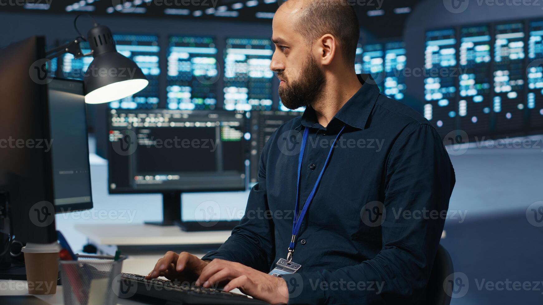 Computer scientist overseeing server hub, typing code on PC, troubleshooting rigs. Software professional doing maintenance on supercomputers, networking systems and storage arrays photo