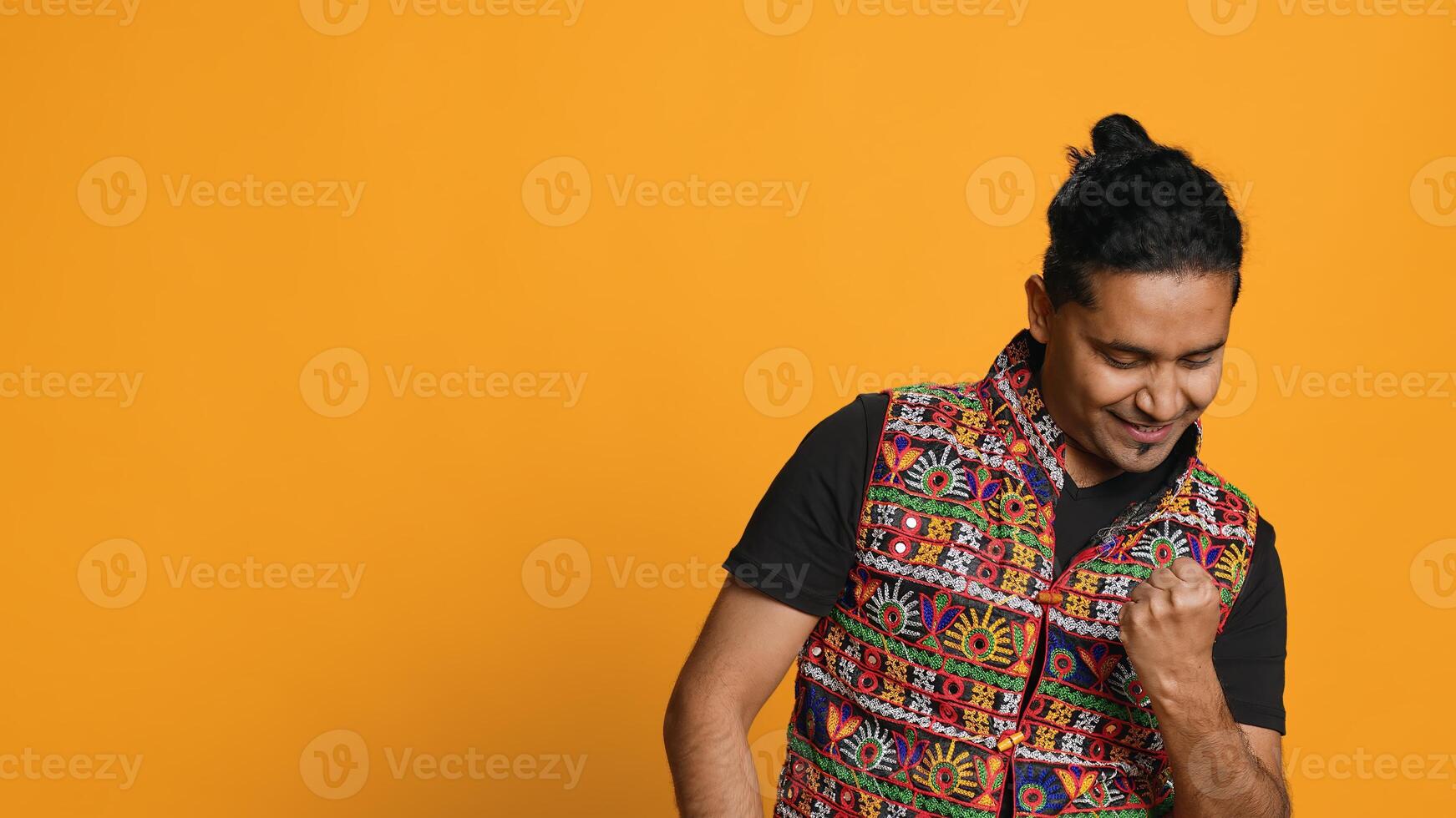 Portrait of narcissistic cheerful indian man celebrating and bragging, showing arrogance. Satisfied person boasting about achievement, cheering and gesticulating, studio background, camera A photo