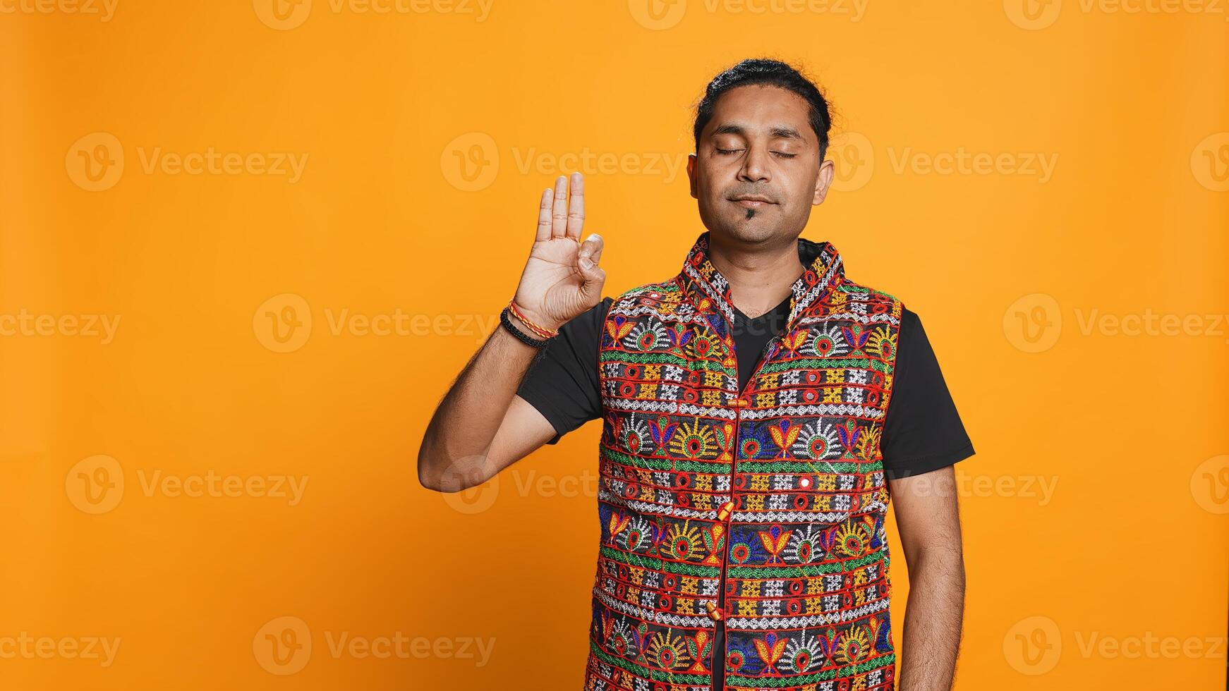 Indian man doing ok hand sign, feeling pleased, agreeing with satisfactory conclusion. Optimistic person doing okay symbol gesturing, offering positive feedback, studio background, camera B photo
