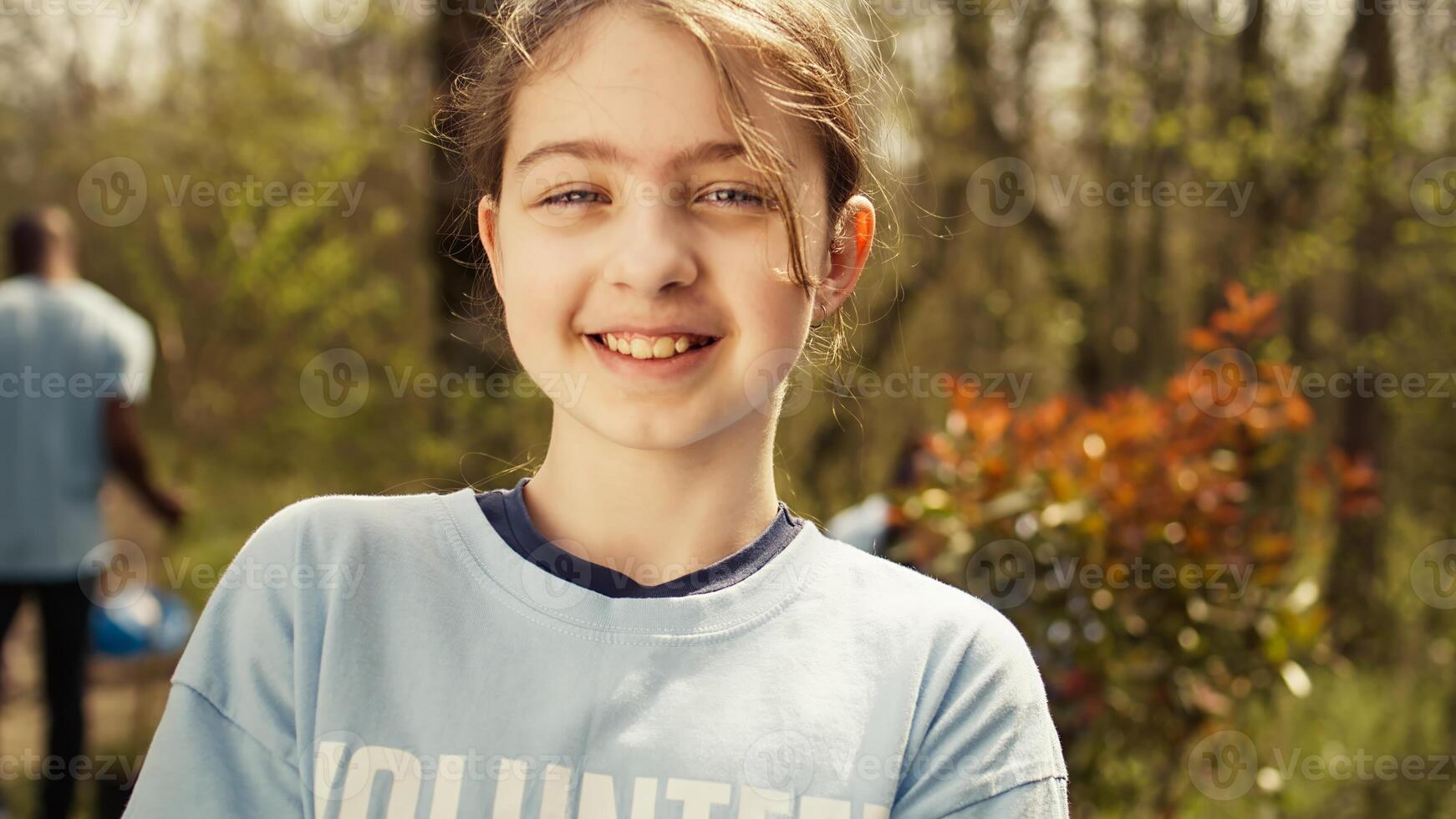 Small child holding soil with a green sprout in her hands, contributing to environmental preservation and natural cultivation. Young activist doing voluntary work to save the planet. Camera B. photo