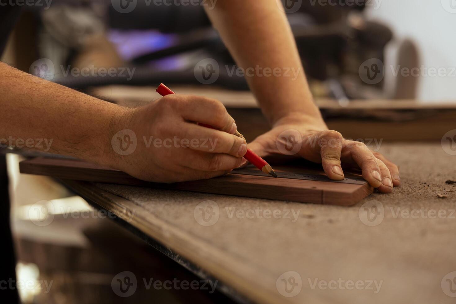 Artisan using ruler to take measurements of plank used to make creative wood sculptures in studio. Man drawing with pencil on wooden board to accurately determine where to make cut, close up shot photo