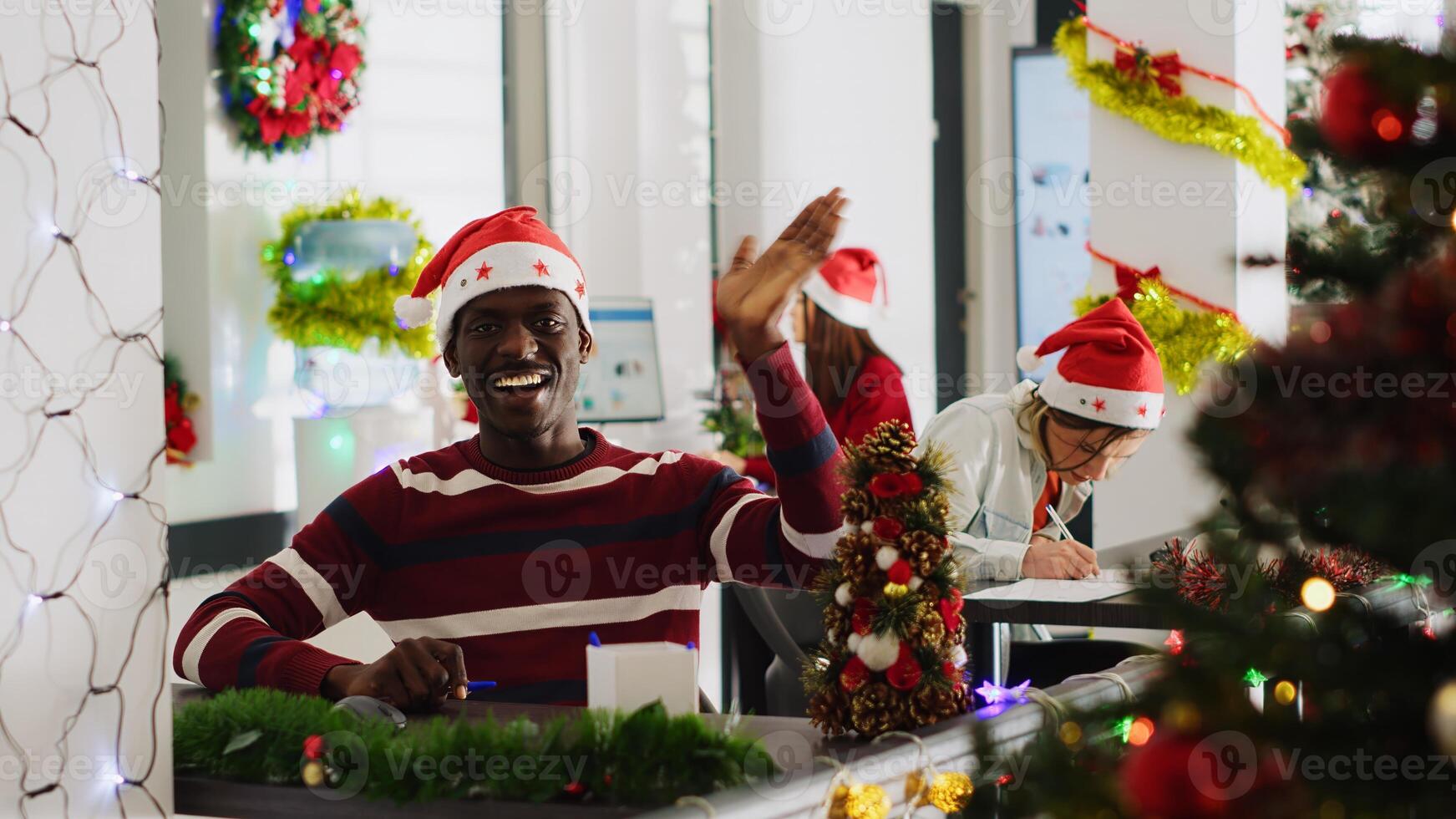 Portrait of african american manager in Christmas decorated office doing vlog for marketing social media channel, talking about company values, trying to recruit new workers photo