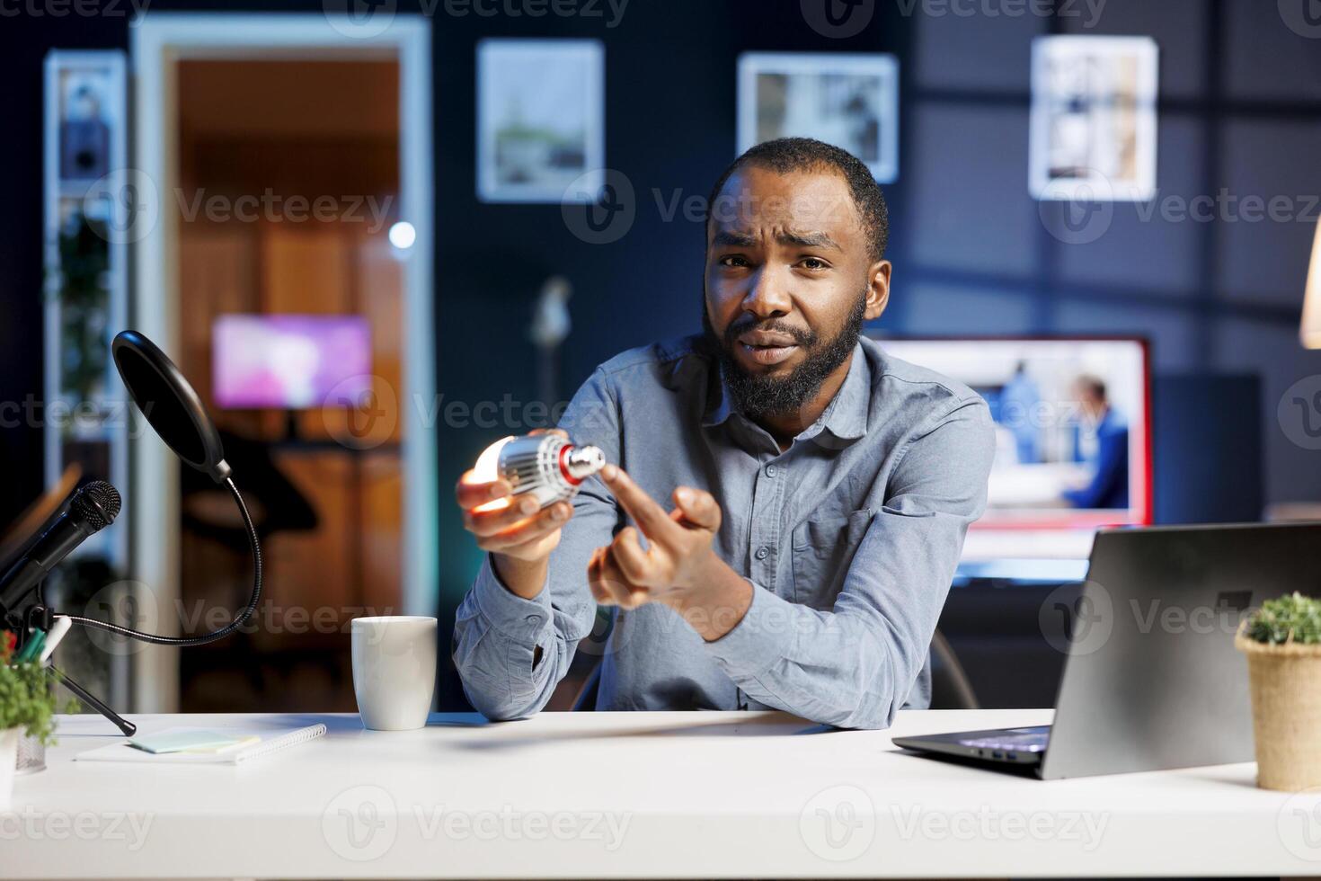 Internet show host being sponsored by partnering brand to do smart light bulb unboxing content. Tech specialist does influencer marketing, doing home automation device product placement photo