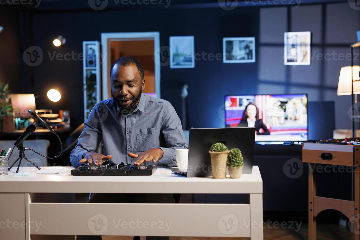 African american man mixing on DJ turntables, doing music production tutorial for his online streaming channel. BIPOC content creator playing around with stereo sound mixer photo