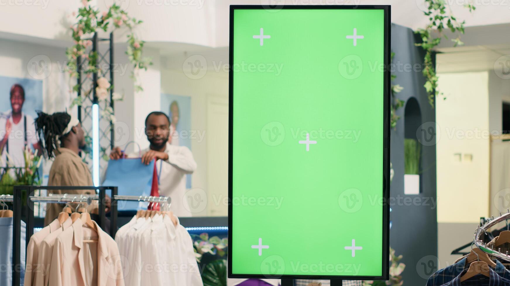Second hand clothing shop green screen kiosk ready to be used by clients to choose between clothes. Chroma key digital display in thrift shop showcasing available garments sizes photo