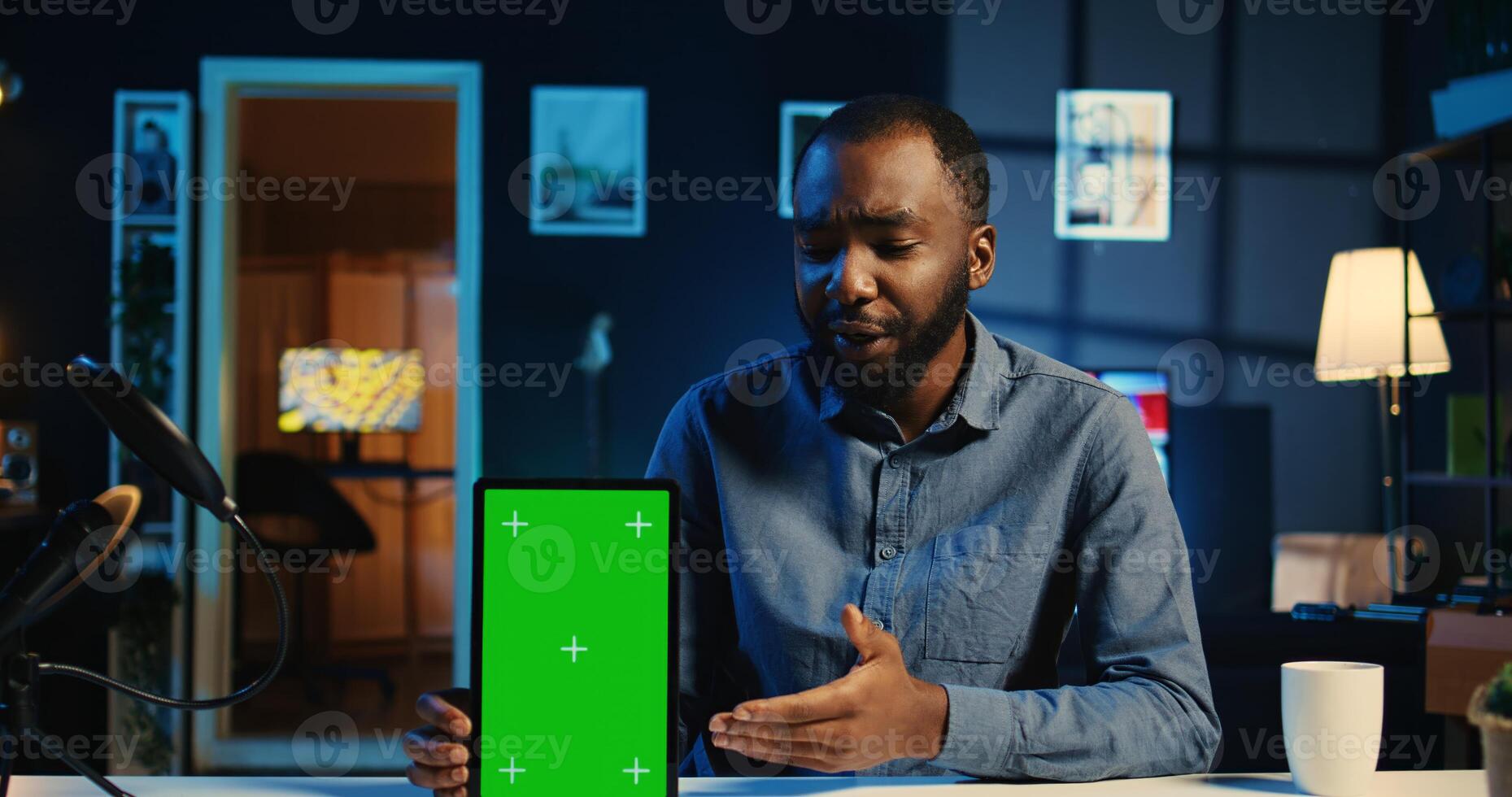Tech content creator filming green screen tablet unboxing, giving reasons to purchase it. Influencer recording urging subscribers to buy sponsoring partner mockup device photo